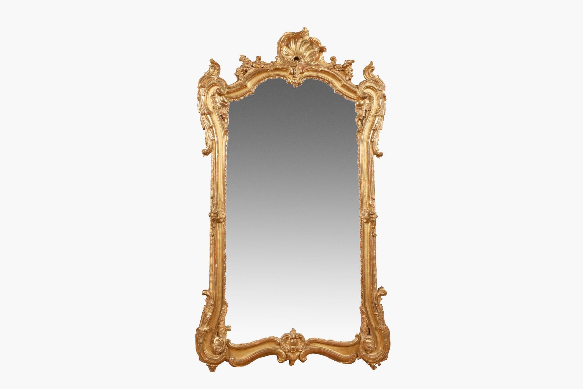 18th century Georgian giltwood pier mirror, the mirror plate set within shaped pierced frame with ruffles, scrolling foliate, acanthus leaf, flower head and S and C scrolls surmounted with scallop shell.