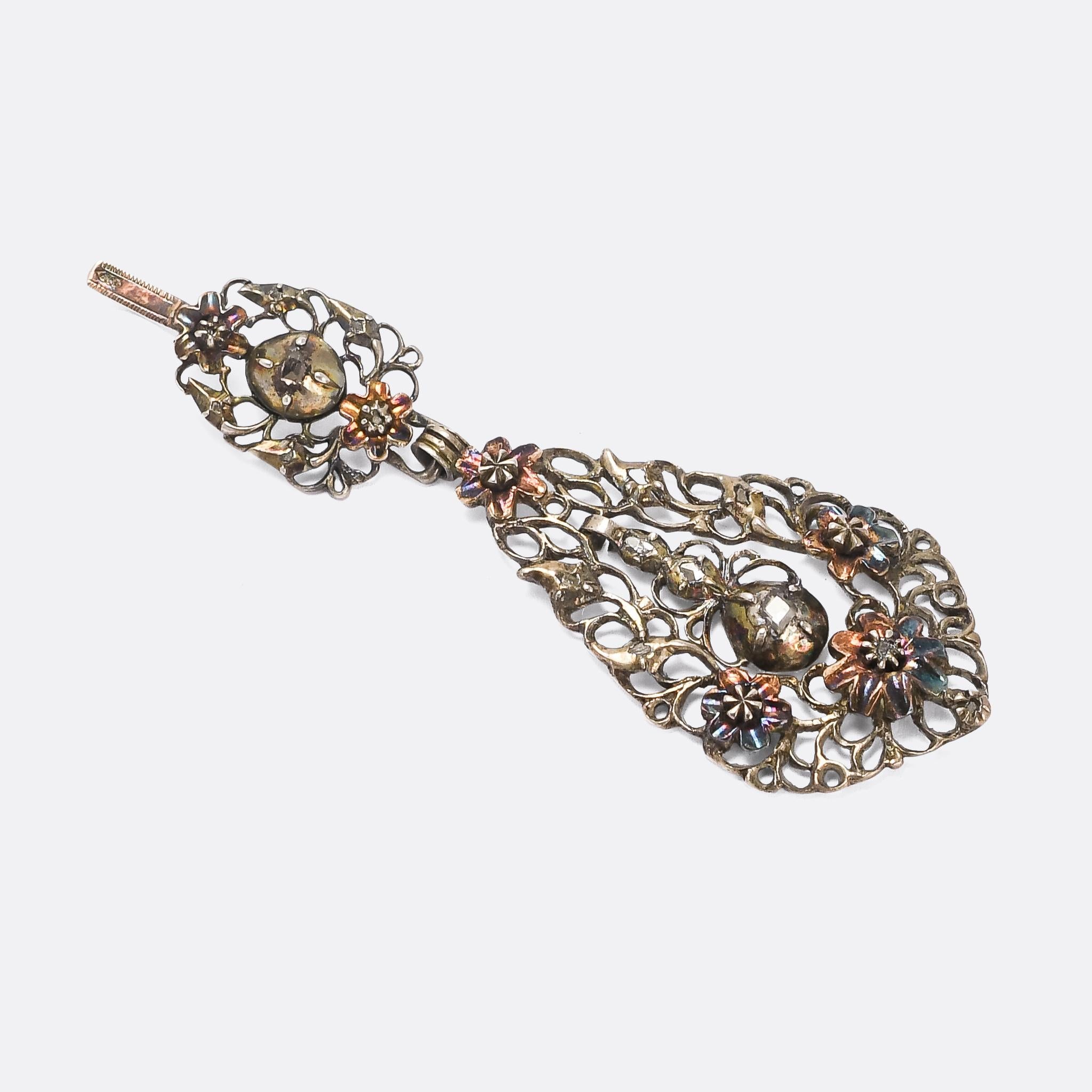An ornate 18th Century diamond pendant from the Iberian peninsula. The style is striking, and instantly recognisable: characterised by the larger scale of pieces, florid floral openwork, domed rub-over settings, and the use of rose cut diamonds.