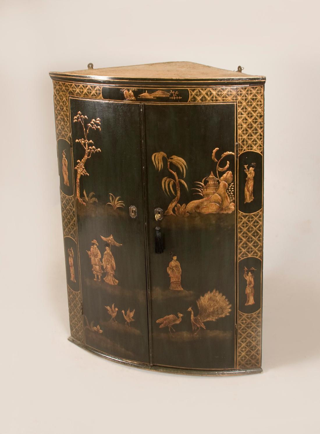This is a English Antique Georgian bowfront cabinet, which has fixed
shelfes inside and a locking door.
The Chinoiserie decoration or Japanning as it is known in Europe,
is beautifully decorated with Figures, Birds, Rocks and Tree's, and
a