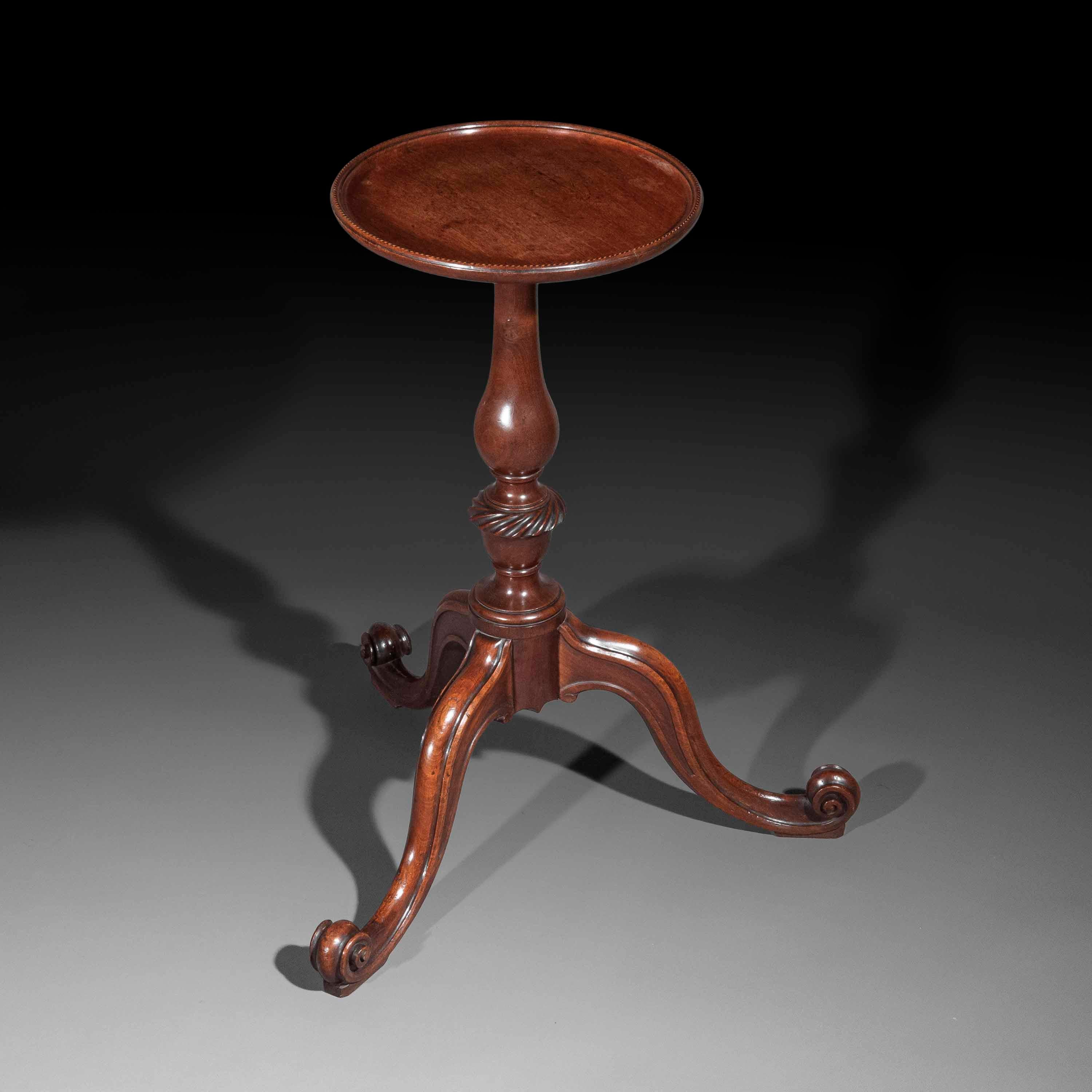 An exquisite 18th century George II kettle stand or wine table in the Chippendale 'French' taste. 
England, circa 1760. 

Why We Like It
We love its superbly drawn outline and the exquisitely carved detail; the mellow, honey colour is most