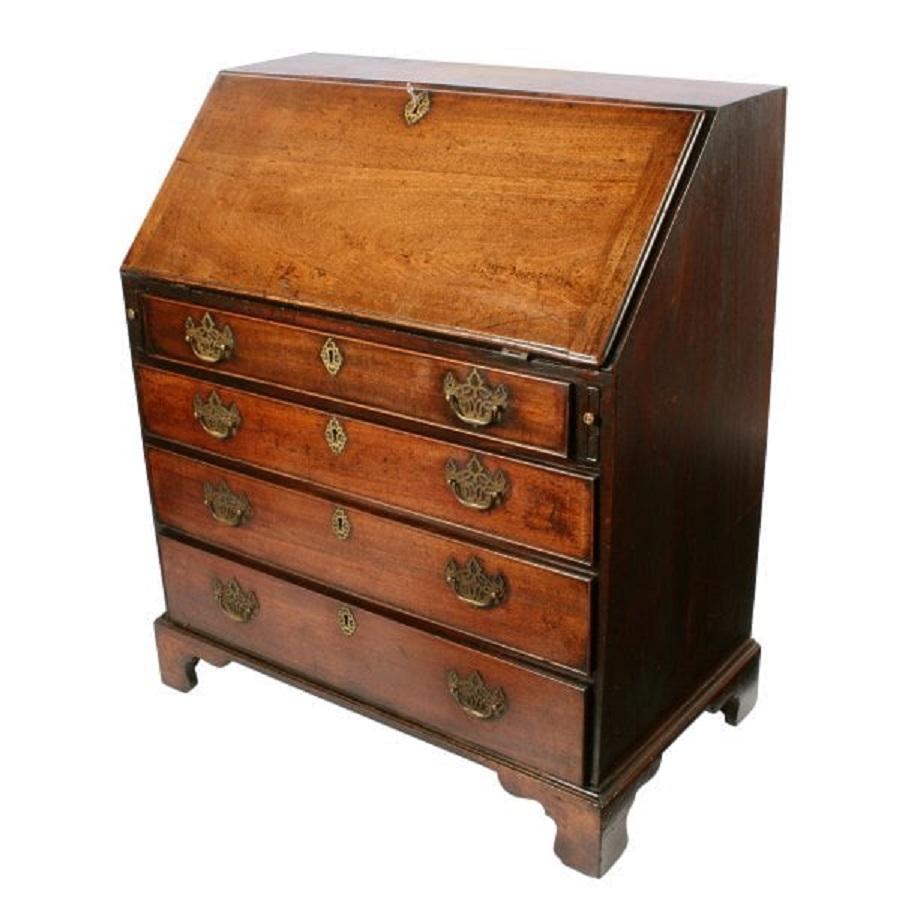An late 18th century Georgian mahogany bureau.

The bureau has four graduated drawers that are pine lined and have pierced brass handles.

The flap when open rests on two pull out supports and inside has six drawers, a cupboard and six pigeon