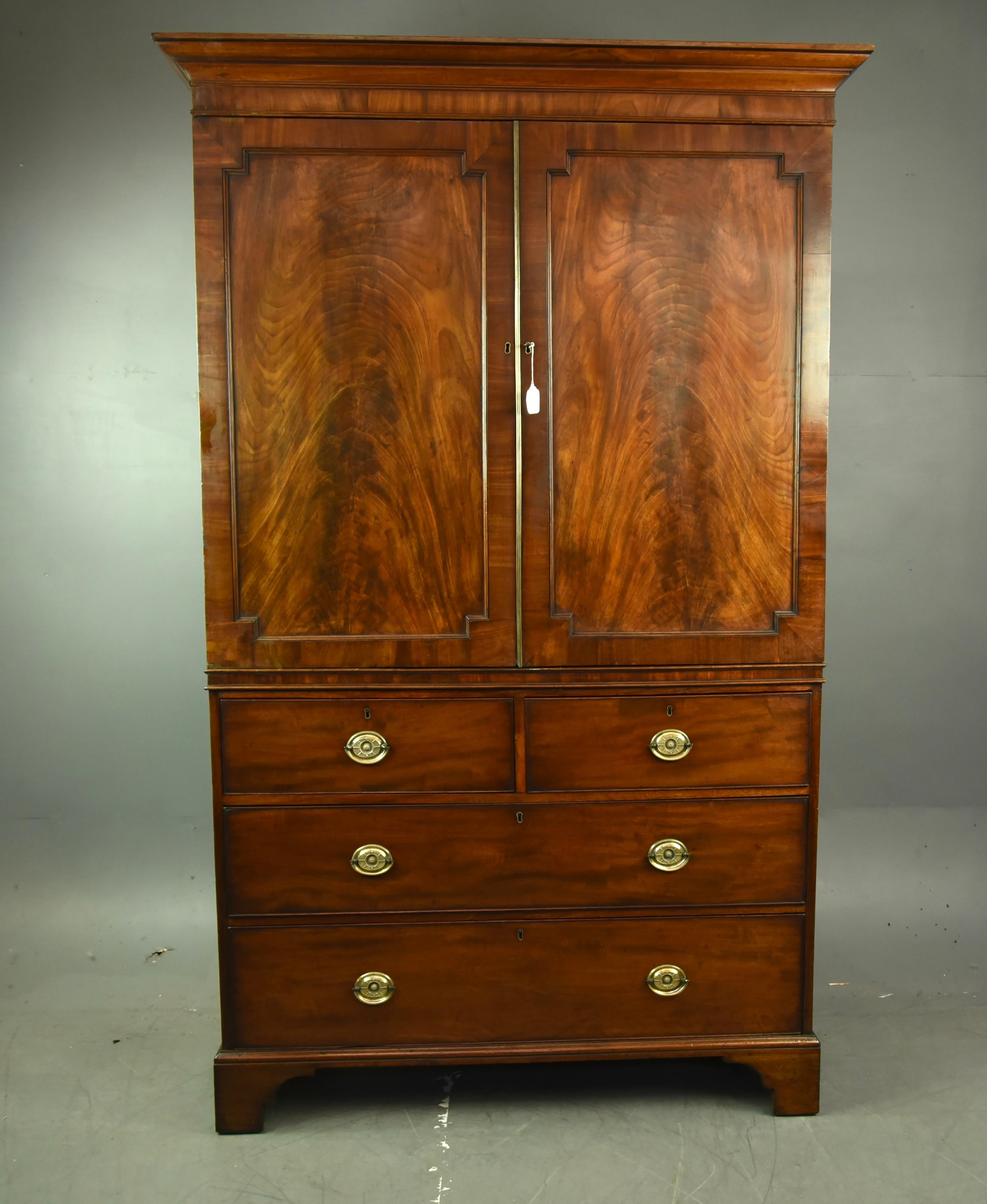 Fine quality Georgian mahogany linen press wardrobe .
The press has two wonderful figured mahogany panel doors with a working lock and key .
The top providing full width hanging with a rail and has ample depth to accommodate modern hangers .
The