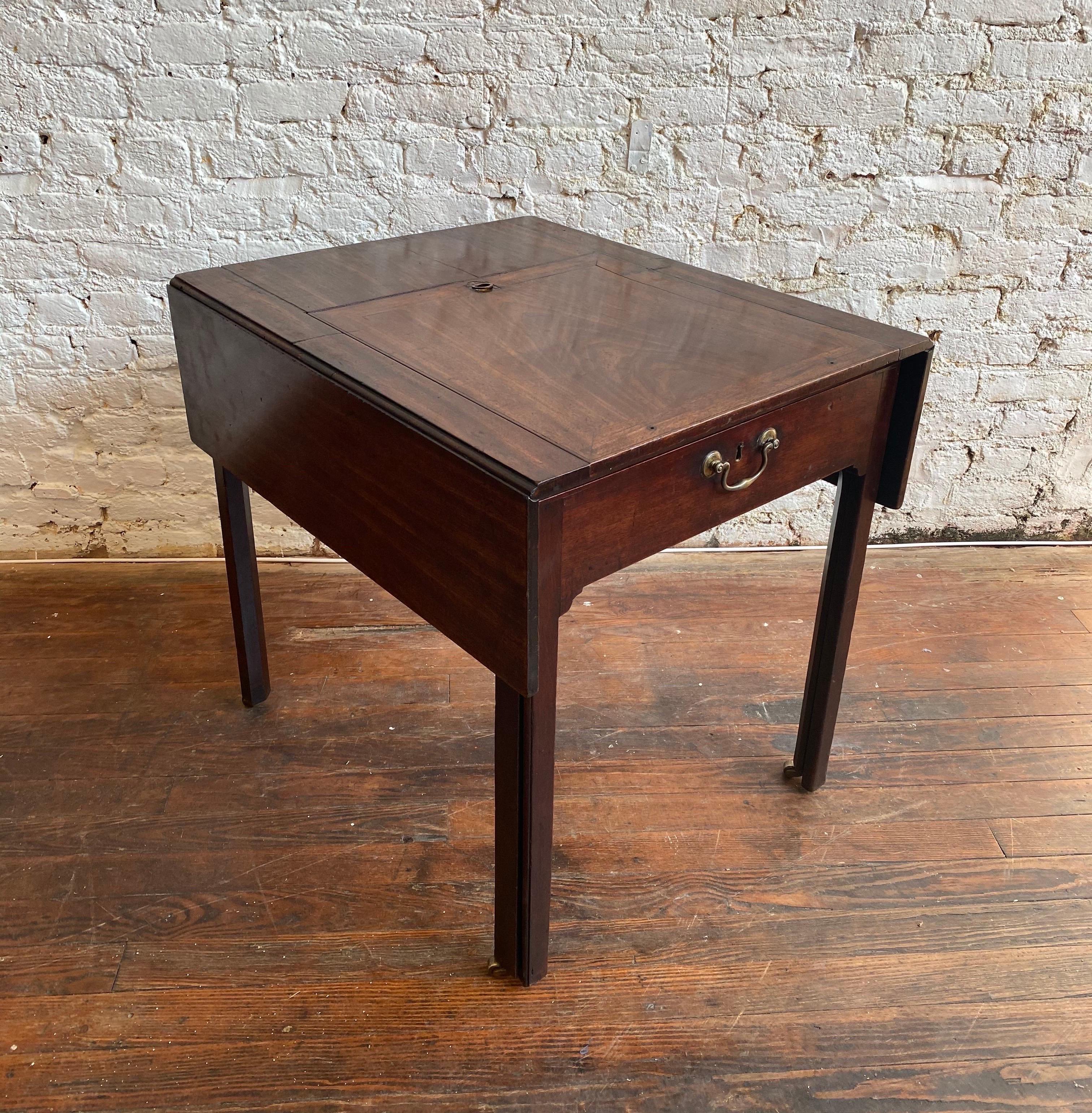 Great 18th century Georgian mahogany metamorphic architect's table. Drop-leaf form top over Marlborough legs with top lifting to 45 degrees. The front slides out on original brass castors to reveal wells and cubbies. Candle slide with carved bone