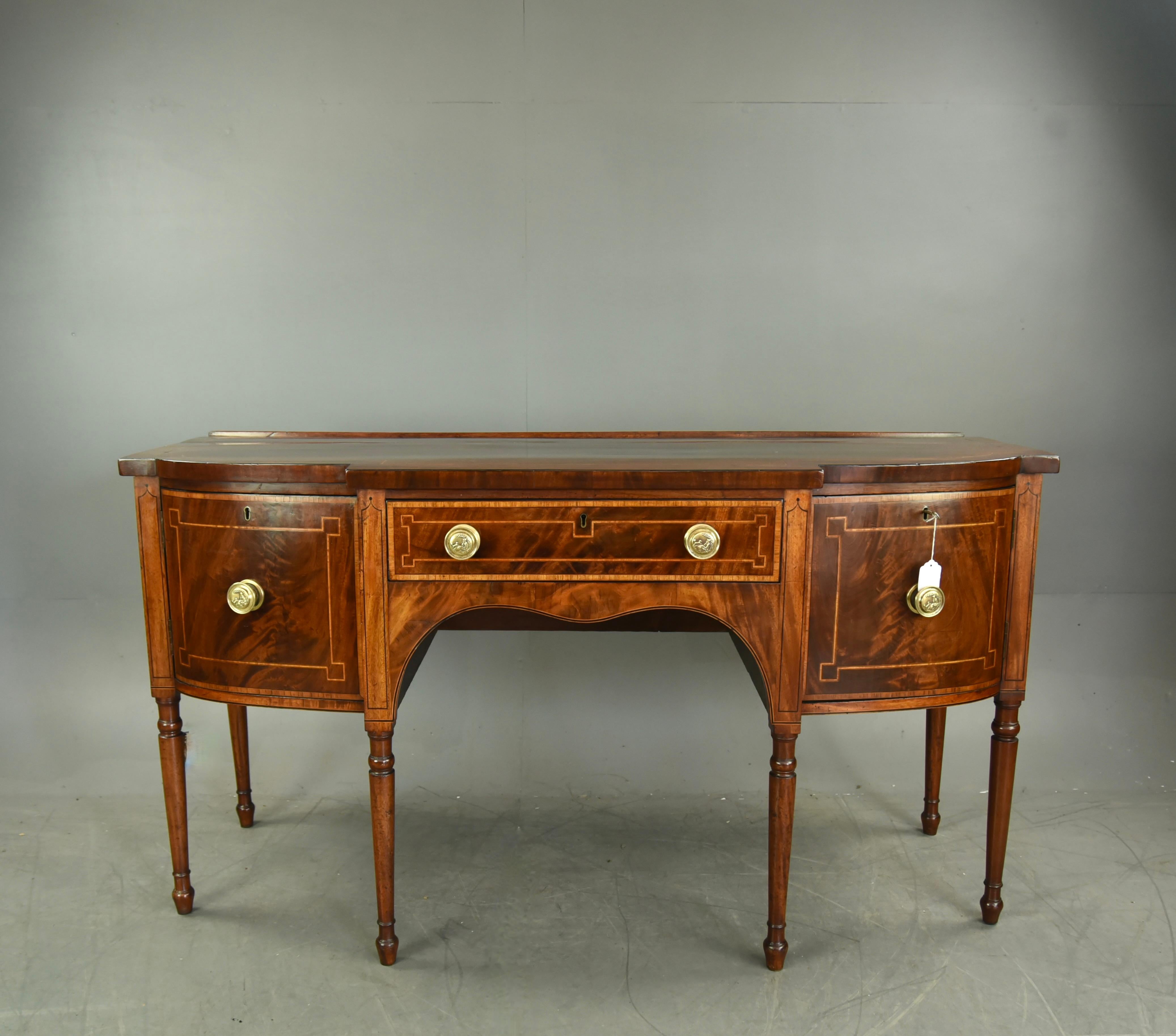 Fine quality Georgian mahogany sideboard circa 1800 .
The sideboard is a great colour with good figuring .and has line inlay detail .
The two end cupboards each have a single shelf and both have working locks with a single key .
The sideboard stands