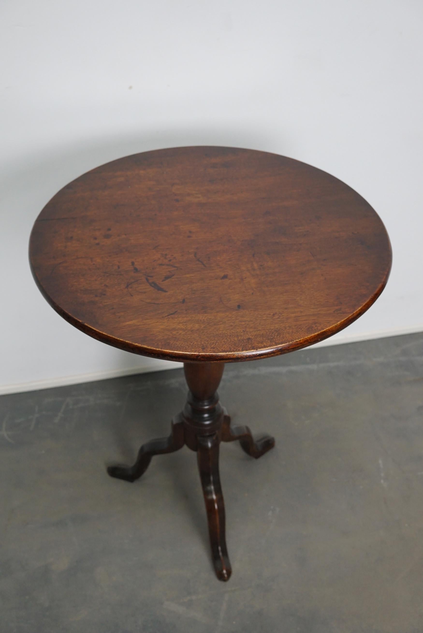 Lovely mahogany wine table from the 18th century. This table features a solid mahogany tilt top on tripod legs. The table has been restored and in a very nice condition.