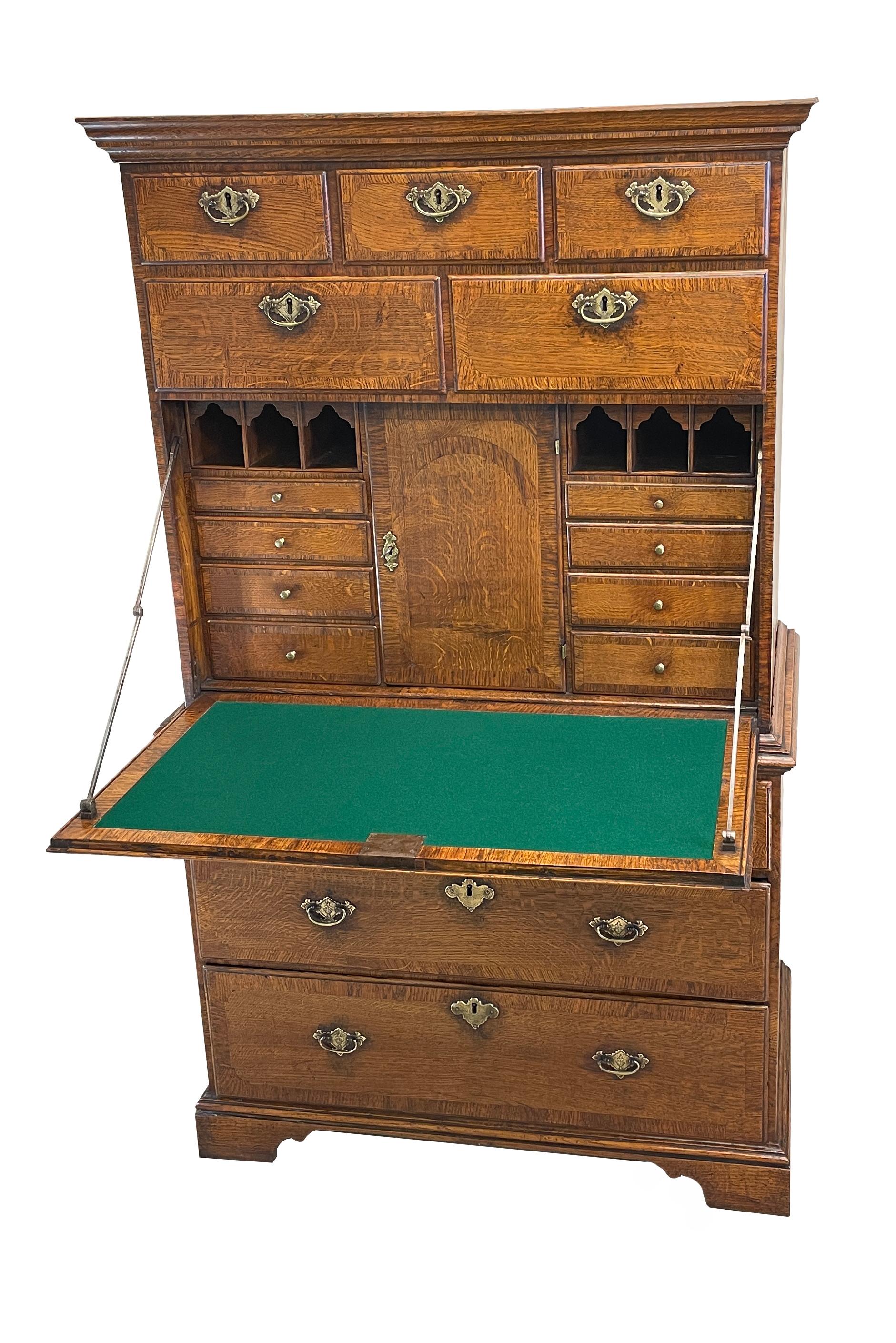 A charming Georgian 18th century George 1 period
oak escritoire, or secrétaire tallboy, of very unusual
design having various drawers surrounding central
fall front enclosing further small drawers, pigeon
holes & cupboard doors, with elegant