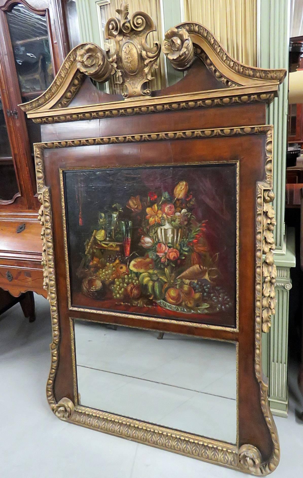 18th century Georgian style trumeau mirror with an oil painting over the mirror and a gilt decorated carved wood frame. The oil painting is 24