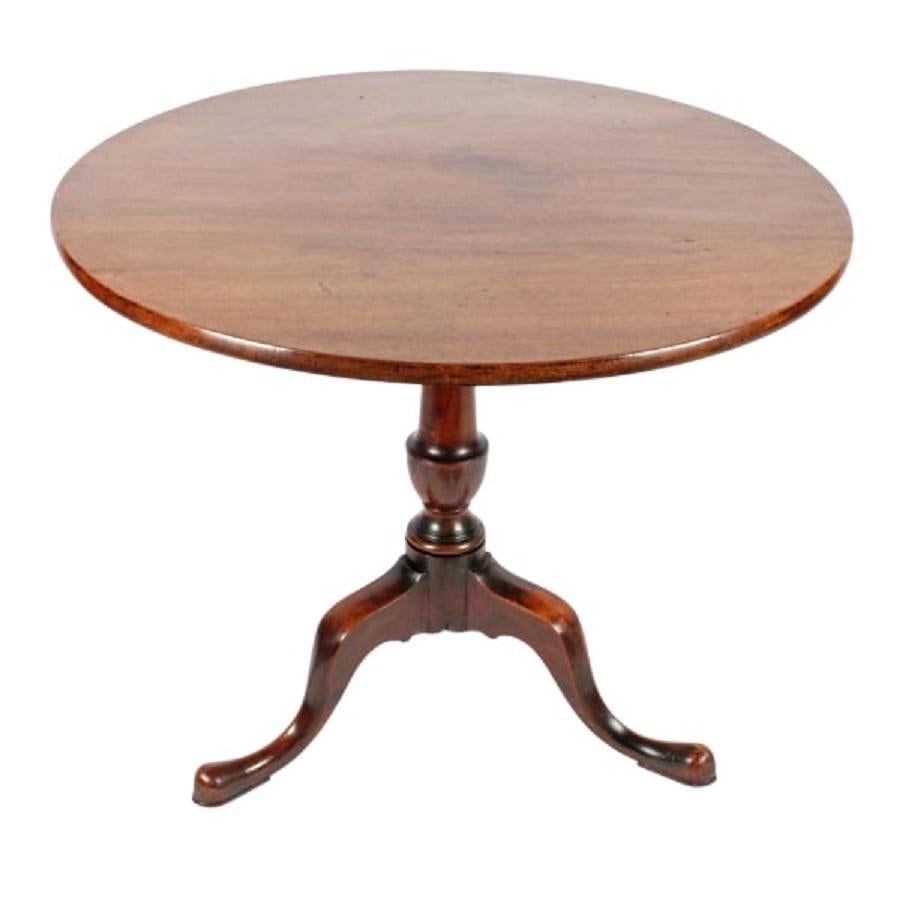 A late 18th century Georgian mahogany tip top supper table.

The table has a figured mahogany single piece top with a rounded edge and a release catch underneath that allows the top to tip.

The table has a tripod base with three cabriole legs