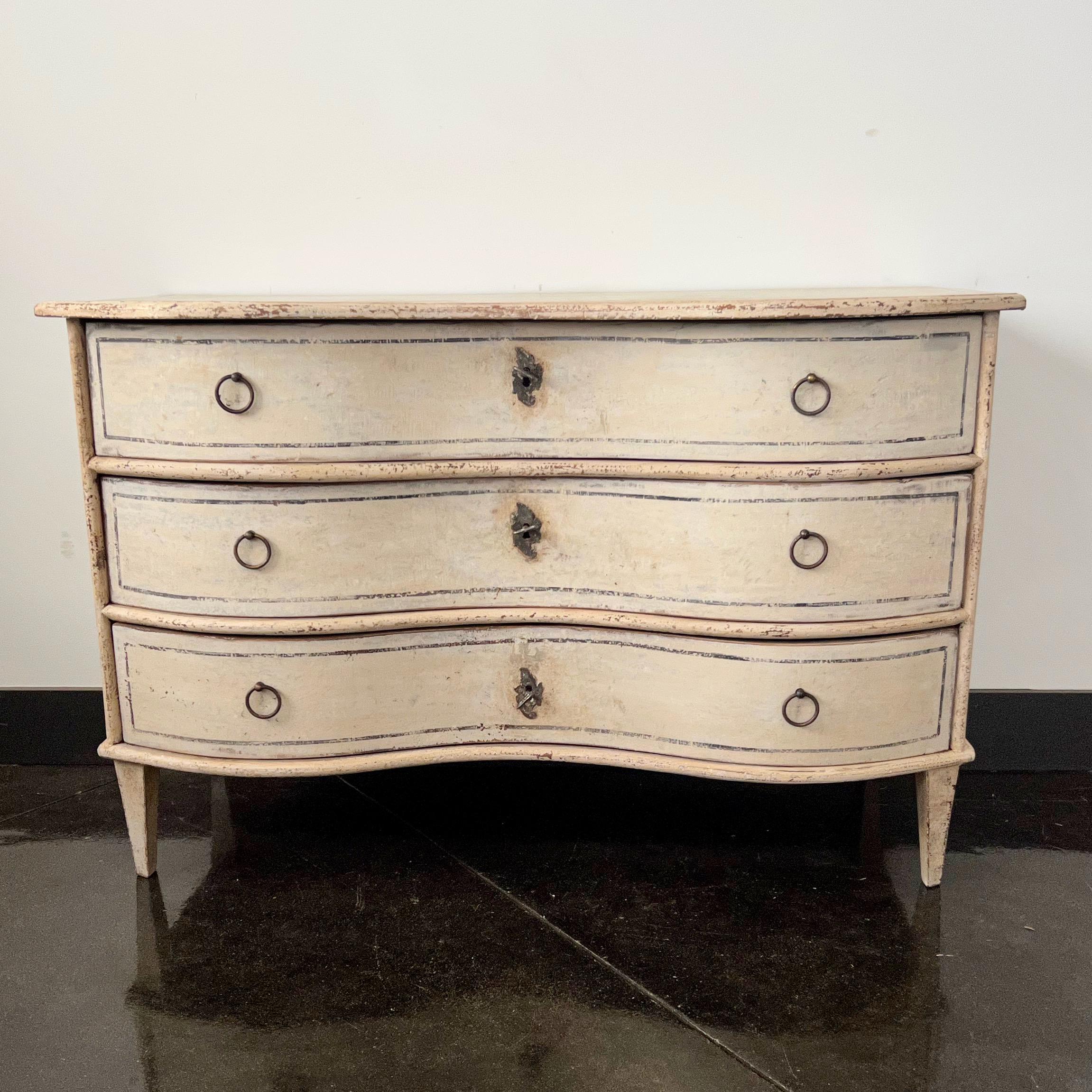 18th Century German Baroque painted chest of drawers with serpentine front drawers on tapered feet in later paint.