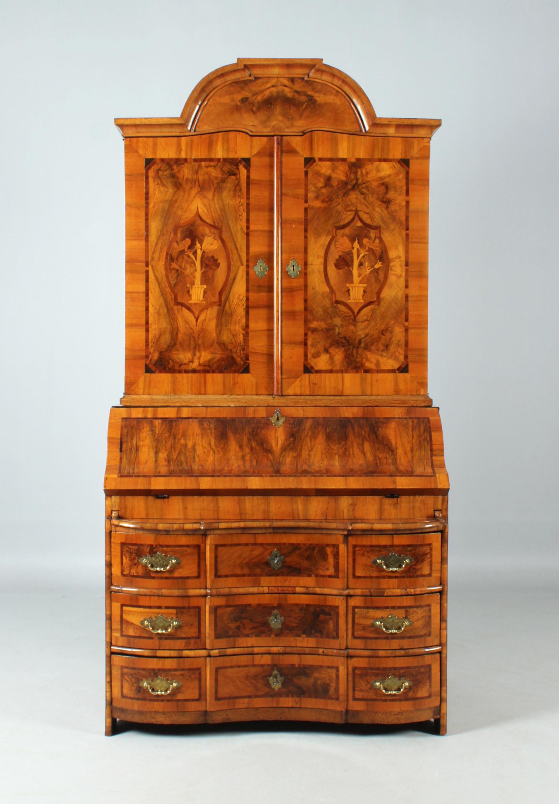 Dimensions: H x W x D: 233 x 117 x 69 cm

Description:
Two-piece top secretary from the Baroque period circa 1750.

The three-bay base is curved in the front, the discreetly accentuated crosspieces and the top edge are made of walnut end-grain