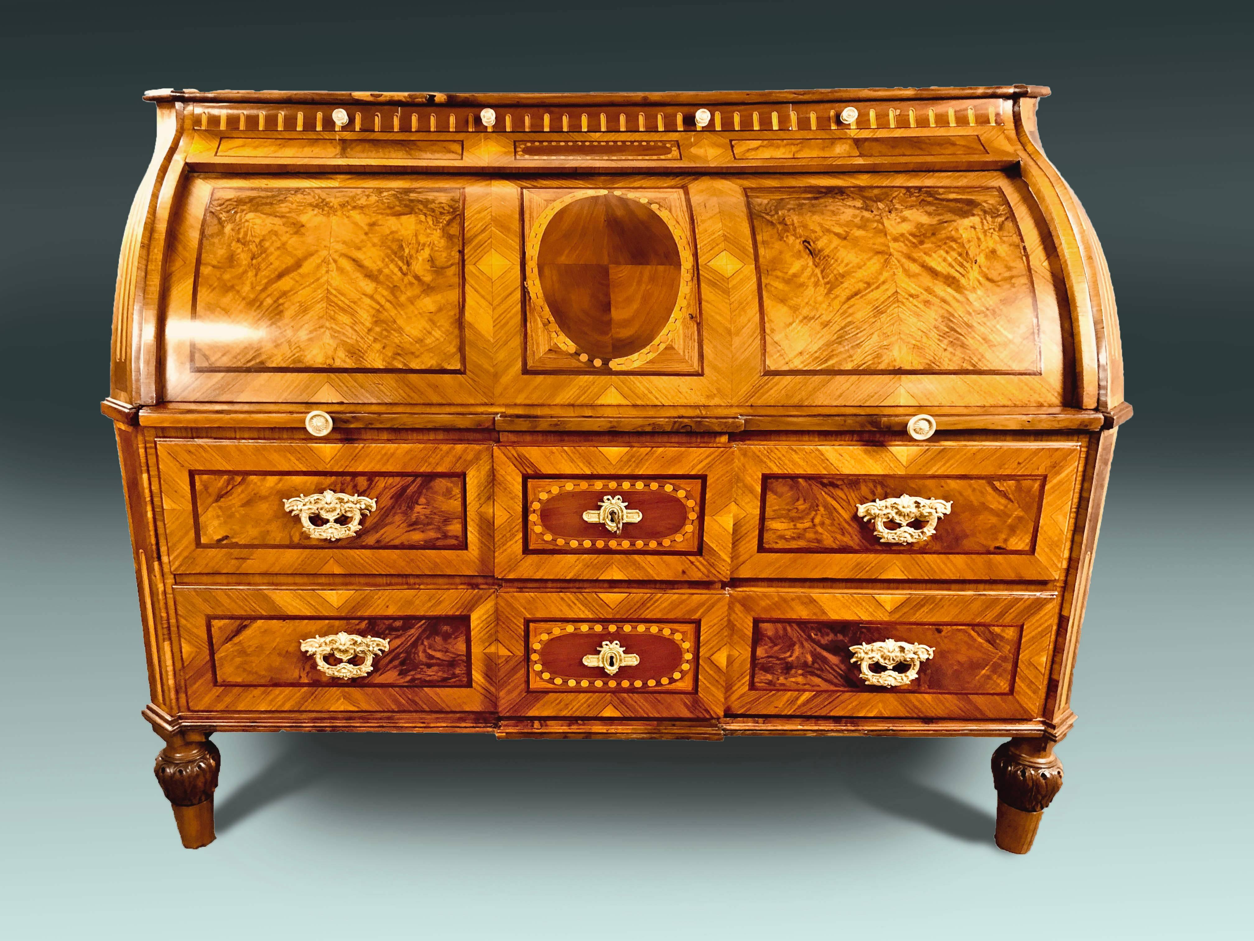 Outstanding 18th century Bureau Secretaire of German origin with cylinder top that rolls open automatically once the sliding writing surface is pulled open. The entire bureau with outstanding contrasting light and dark walnut veneers and intricate