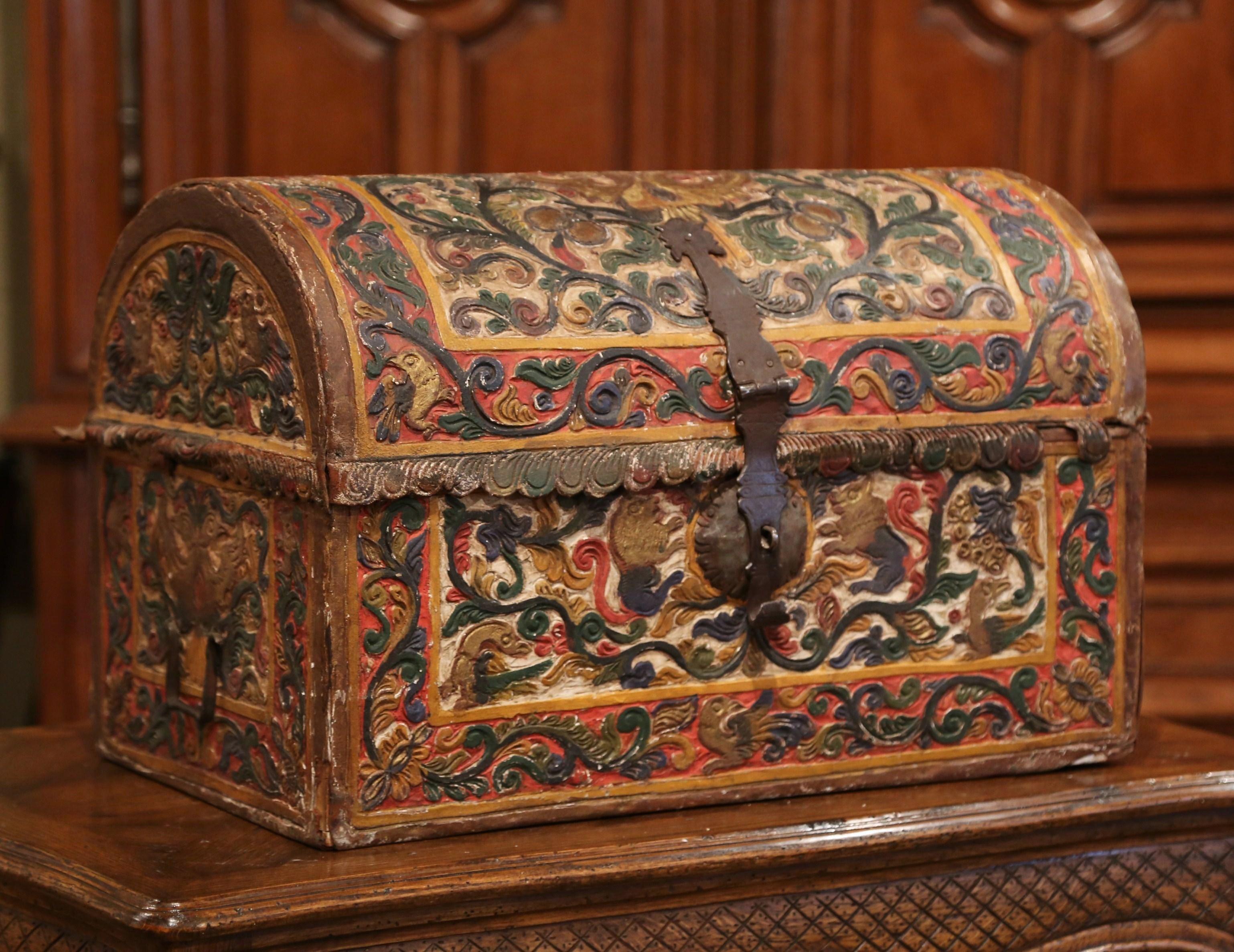 This beautifully executed antique wedding trunk was crafted in Germany, circa 1780. The decorative, arched box has iron side handles and an impressive front lock mechanism; it features hand painted scroll decor with original thick paint in the