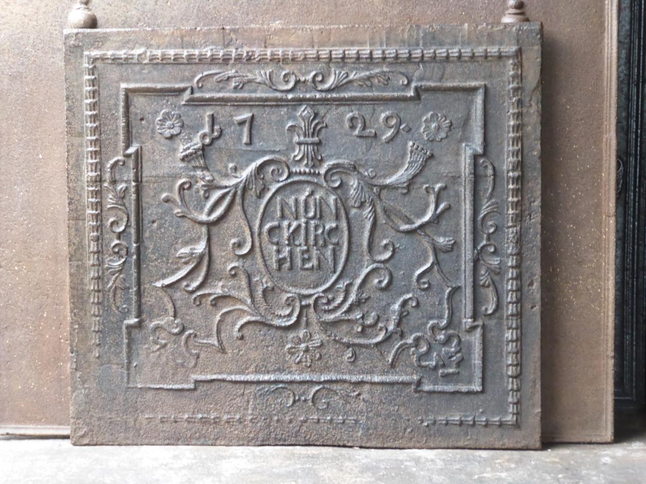 German Louis XV fireback with decoration around the name Nünckirchen. It refers to the former foundry at Neunkirchen in Germany which operated since 1593. The date of production, 1729, is also cast in the fireback. The fireback has a natural brown