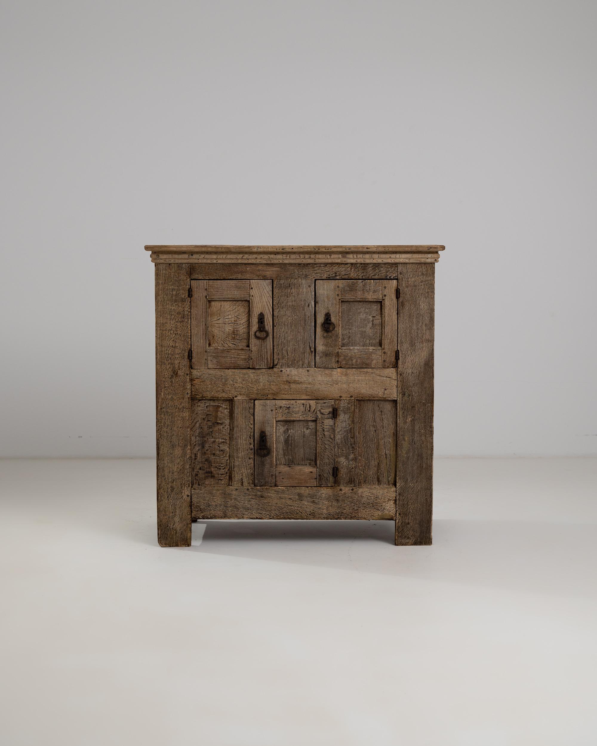 Simple, rustic and beautifully constructed, this antique oak buffet has stood the test of time. Made in Germany in the 1700s, decoration is kept to a minimum– allowing the thoughtful composition to speak for itself. A trio of square doors creates a