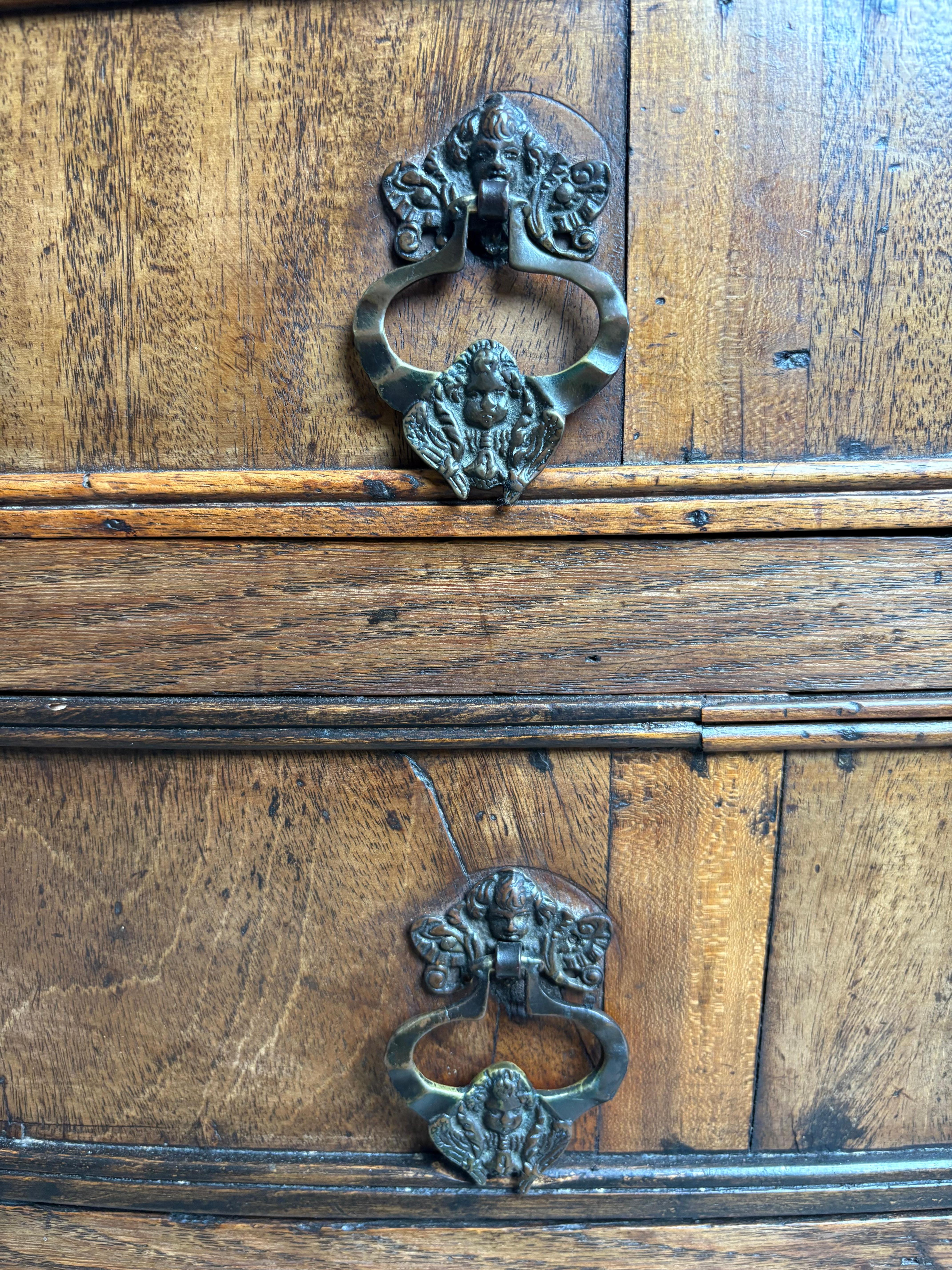 Rare mid C18th German Oak bow fronted commode / chest of drawers of very unusual design with outstanding colour and  patination. The top with has an intriguing geometrical  design incorporating walnut lozenges. With four graduating drawers all