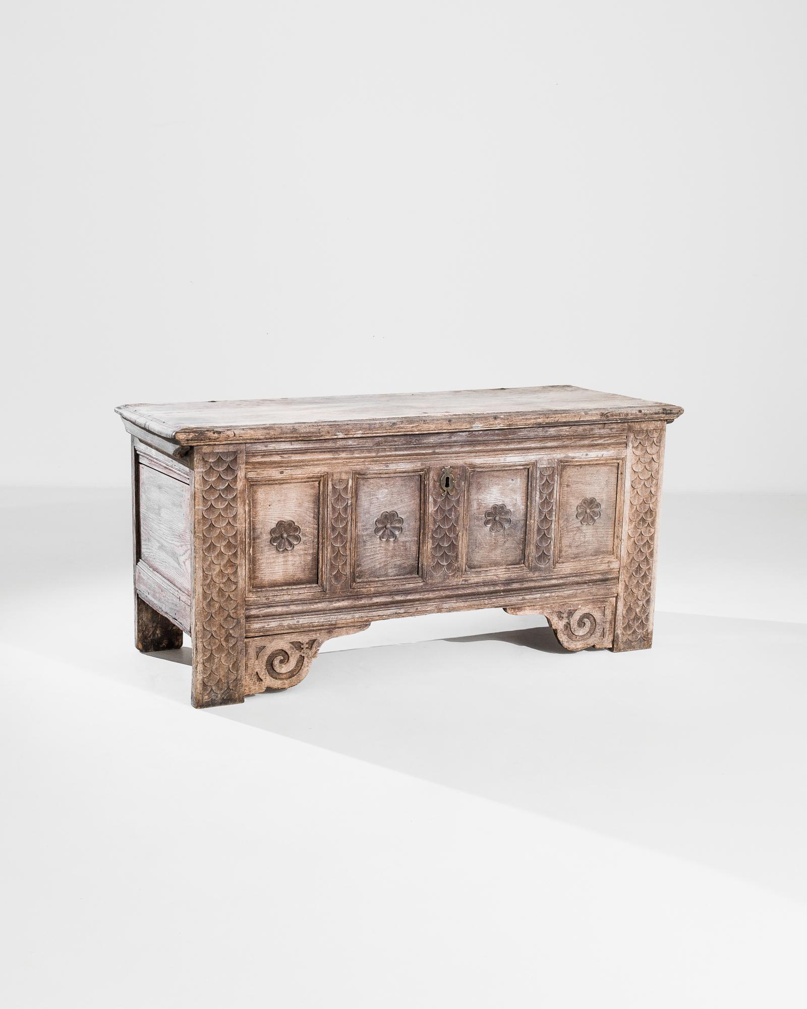 Made to safeguard your precious treasures, this impressive wooden chest made in Germany circa 1780. Elaborate ornamentation on the front includes diverse sea motifs such as a fish scale pattern on the sides and scrollwork molded underneath four