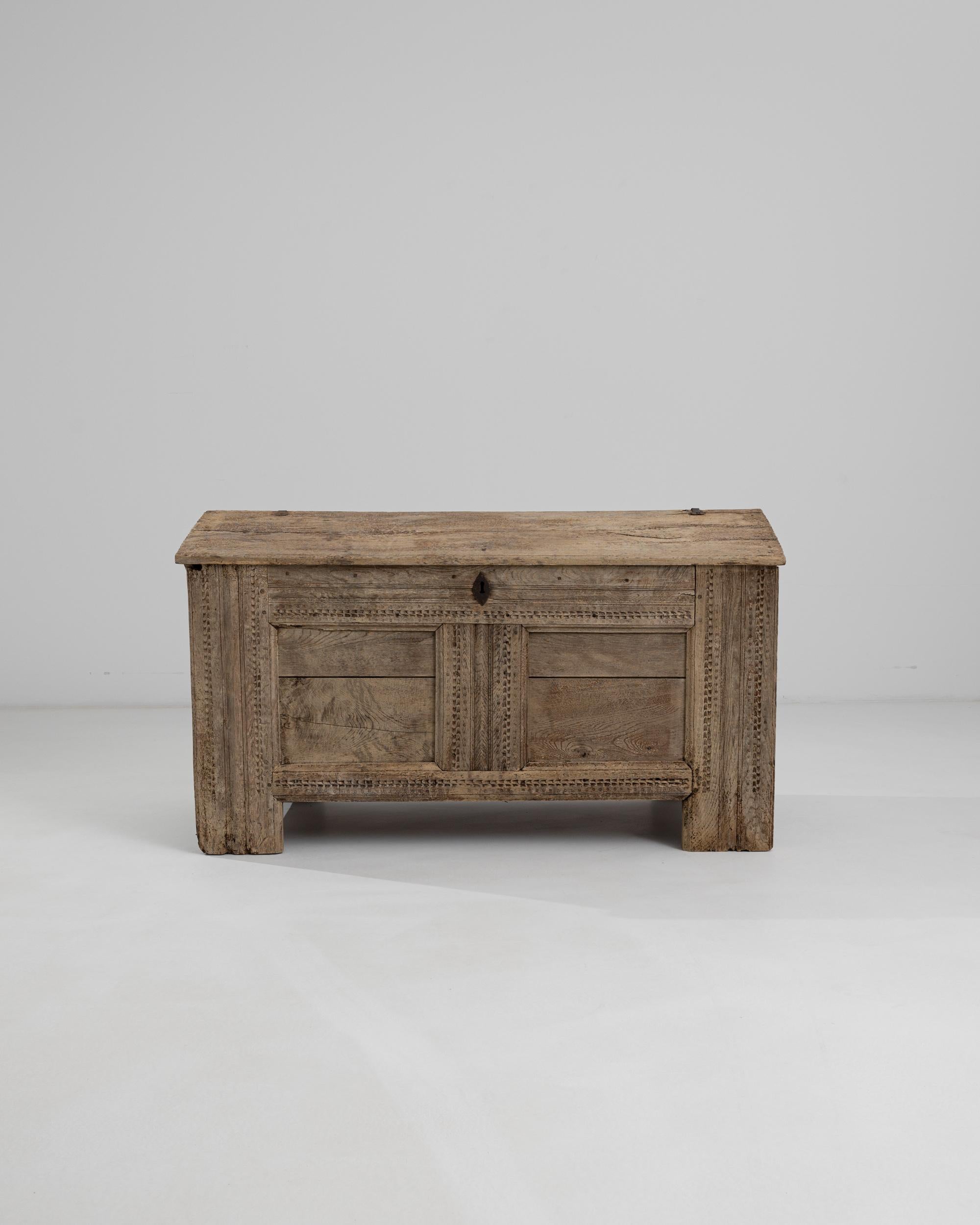 This gothic trunk in natural oak offers a unique antique accent. Made in Germany in the 1700s, the peaked lid gives the piece an architectural quality, reminiscent of ancient dwellings such as Viking longhouses; the subtle carved edges of the lid