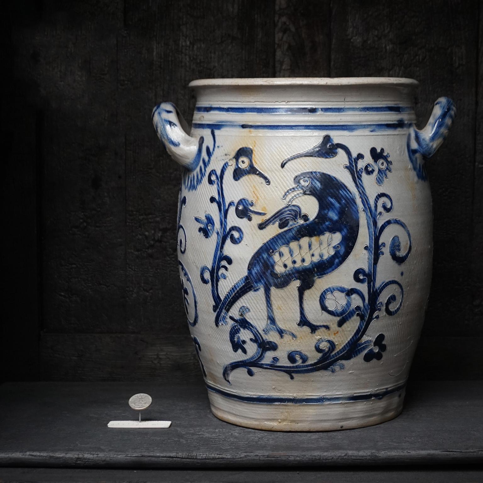 Large three gallon Westerwald crock pot, open salt glazed two-handled stoneware jar.
Decorated with elaborate bird decoration, great collectors’ items.

The ovoid shaped jar with loop handles is decorated on the front and back with Ritzdekor and
