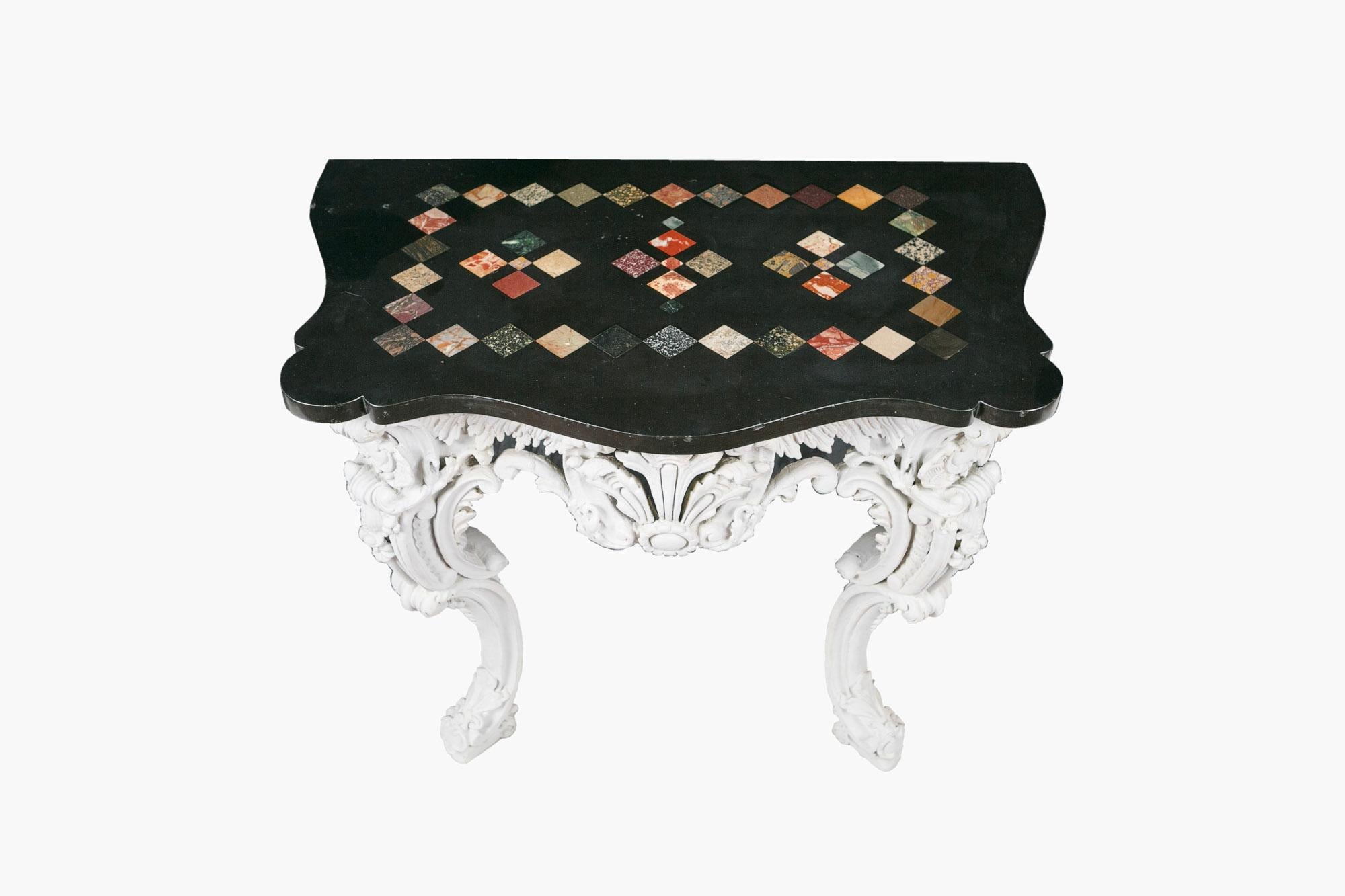 18th century serpentine gesso and marble console table, the moulded specimen marble top raised over ornately carved frieze with centred plumed foliate motif flanked with C-scrolls and acanthus detail supported on cabriole leg with ornate C-scrolls,