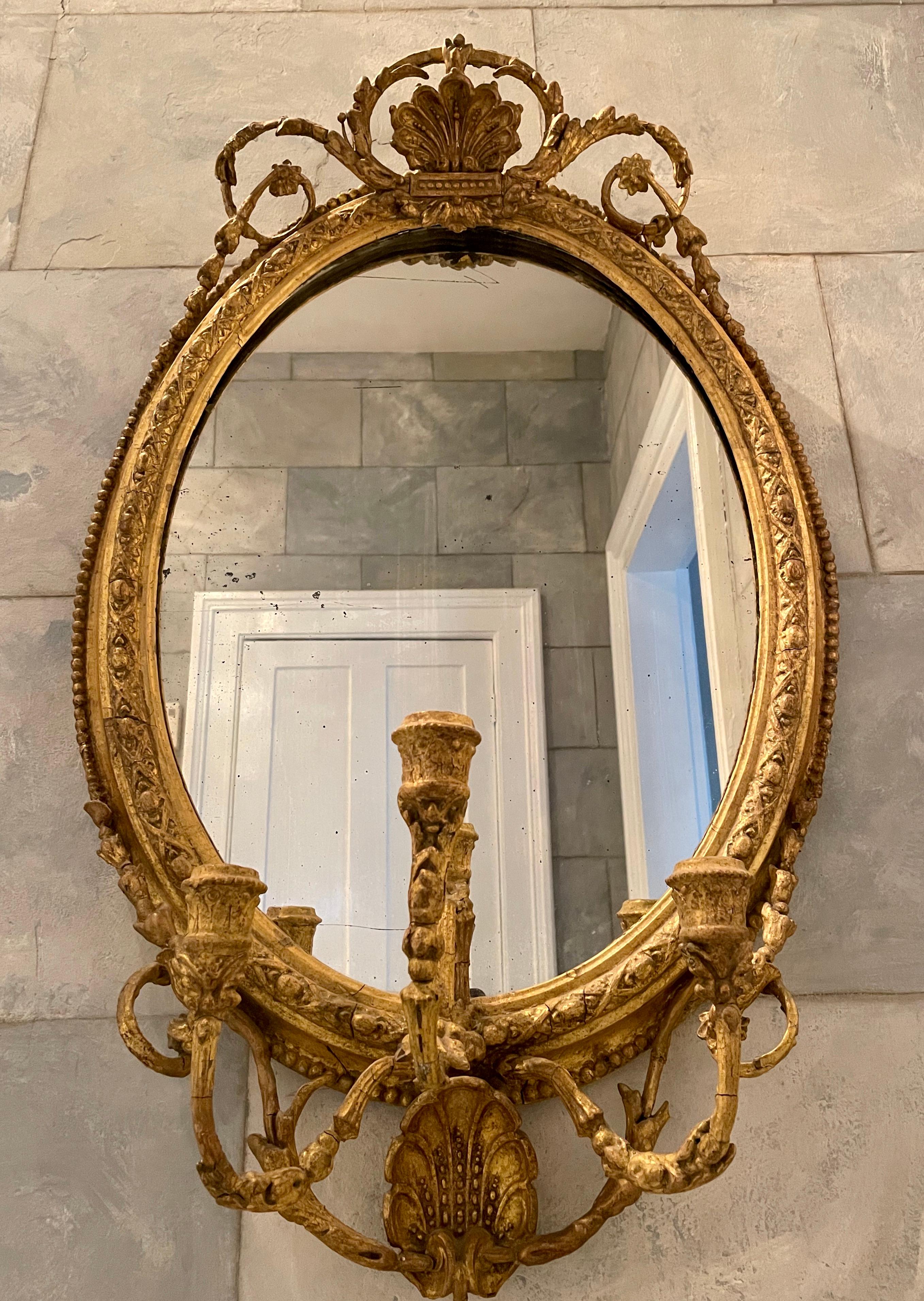 European 18th Century Gilded Oval Girandole Mirror with Triple Candelabra For Sale