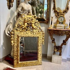18th century gilded wood pediment mercury glass mirror decorated with putti
