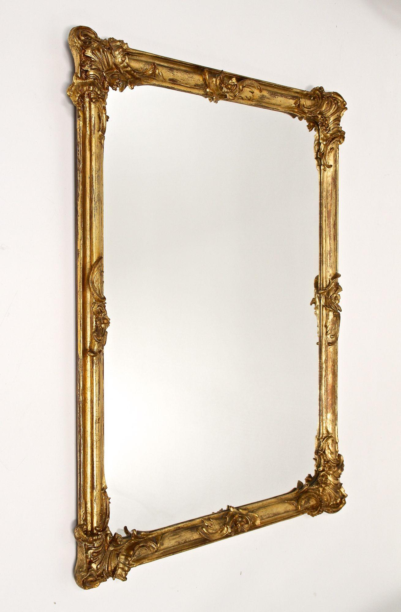 Marvellous 18th century gilt wall mirror from the baroque period around 1780 in Austria. This large, exceptional looking mirror was part of a private owned castle and comes in amazing old restored condition: we just had to carefully clean the frame