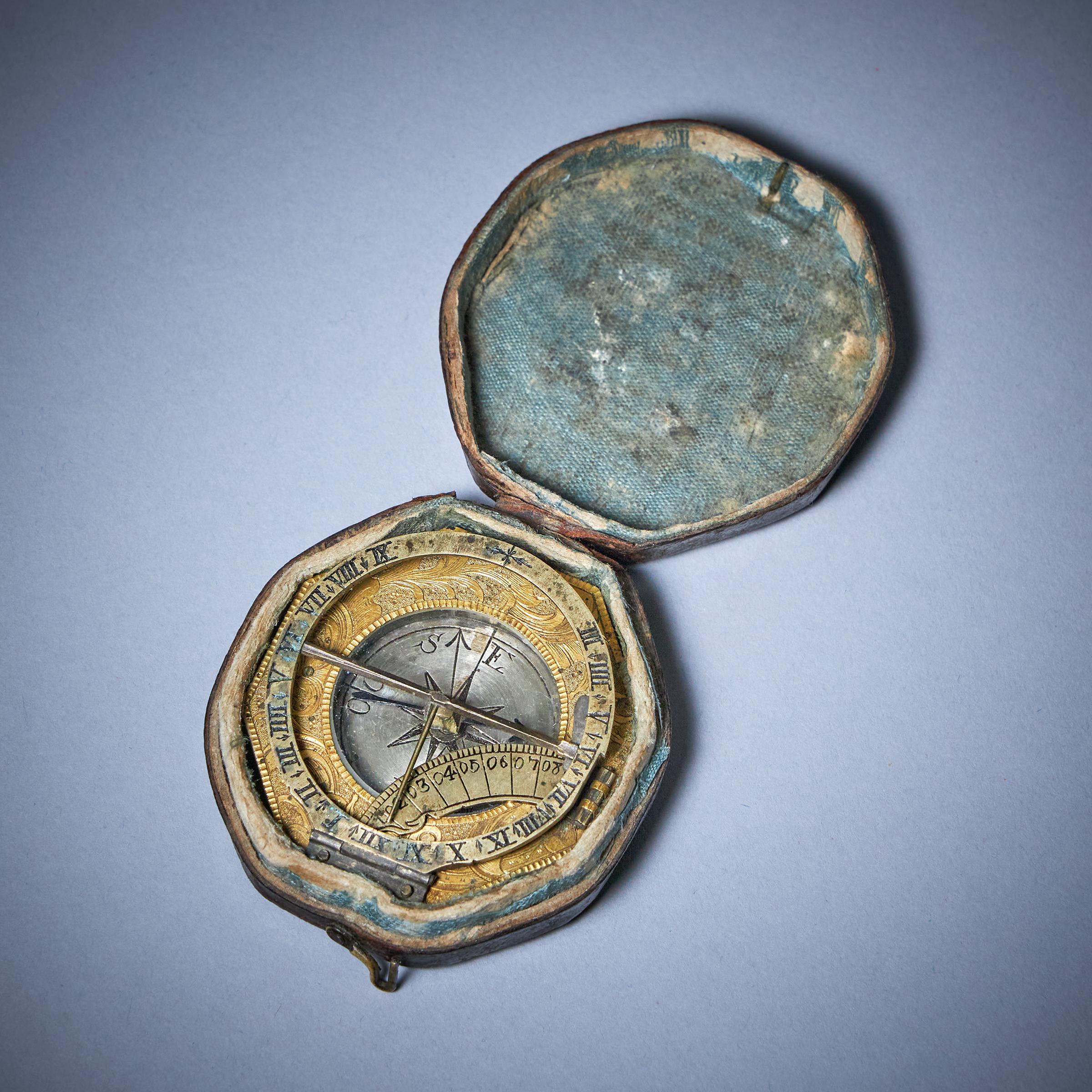 A Fine 18th century gilt brass and silver pocket sundial with Travelling case, c. 1750.
 
A richly engraved gilt brass and silver German equinoctial sundial, monogrammed on the back IGV (for Johann Georg Vogler). The octagonal gilt brass base has