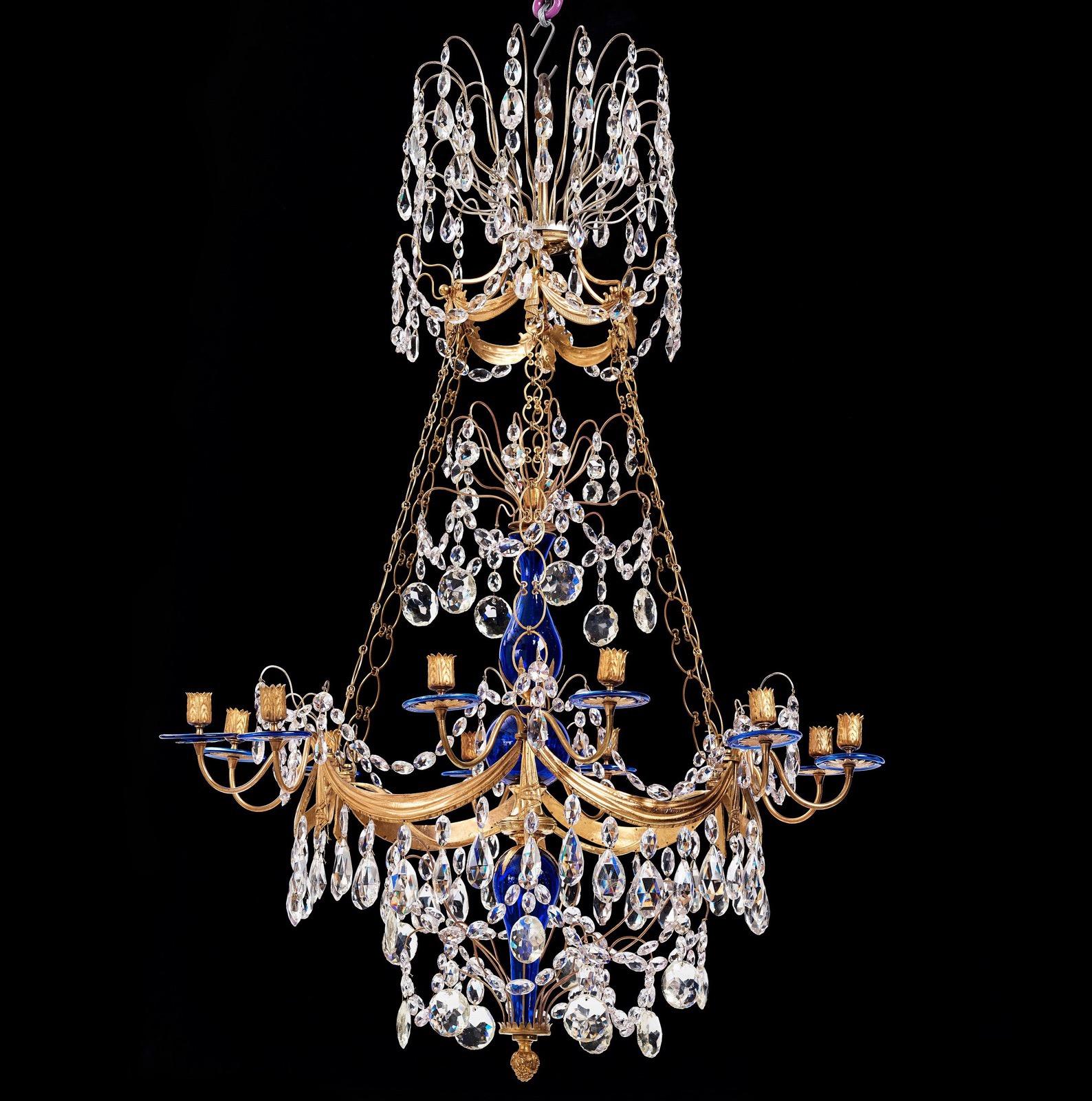 A beautiful Russian chandelier from the Louis XVI period c. 1790 in gilt bronze and with cut-glass crystals. The center with baluster shaped blue glass. The lower main drapery shaped gilt bronze ring with six linked gilt bronze candle arms with a