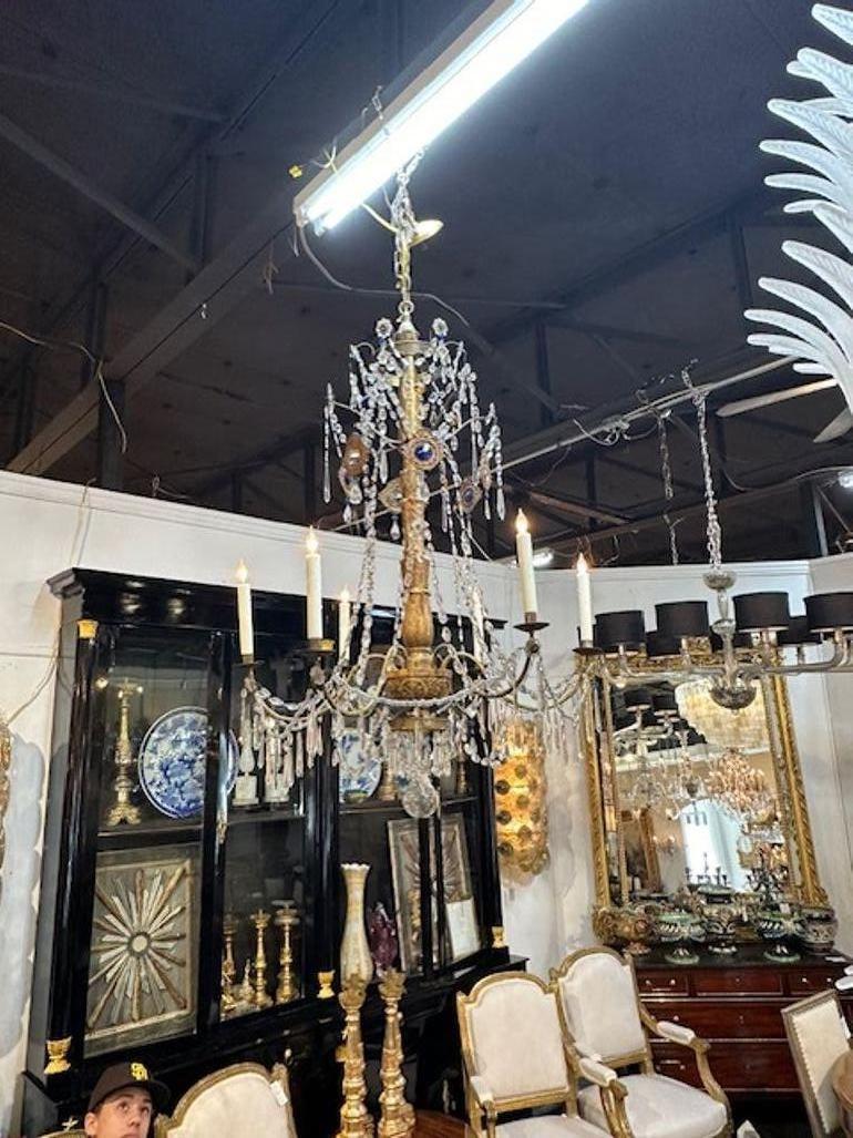 Very fine 18th century Italian giltwood and crystal chandelier from Genoa. Notice the colored crystals and the gorgeous carving on the base. Beautiful!!