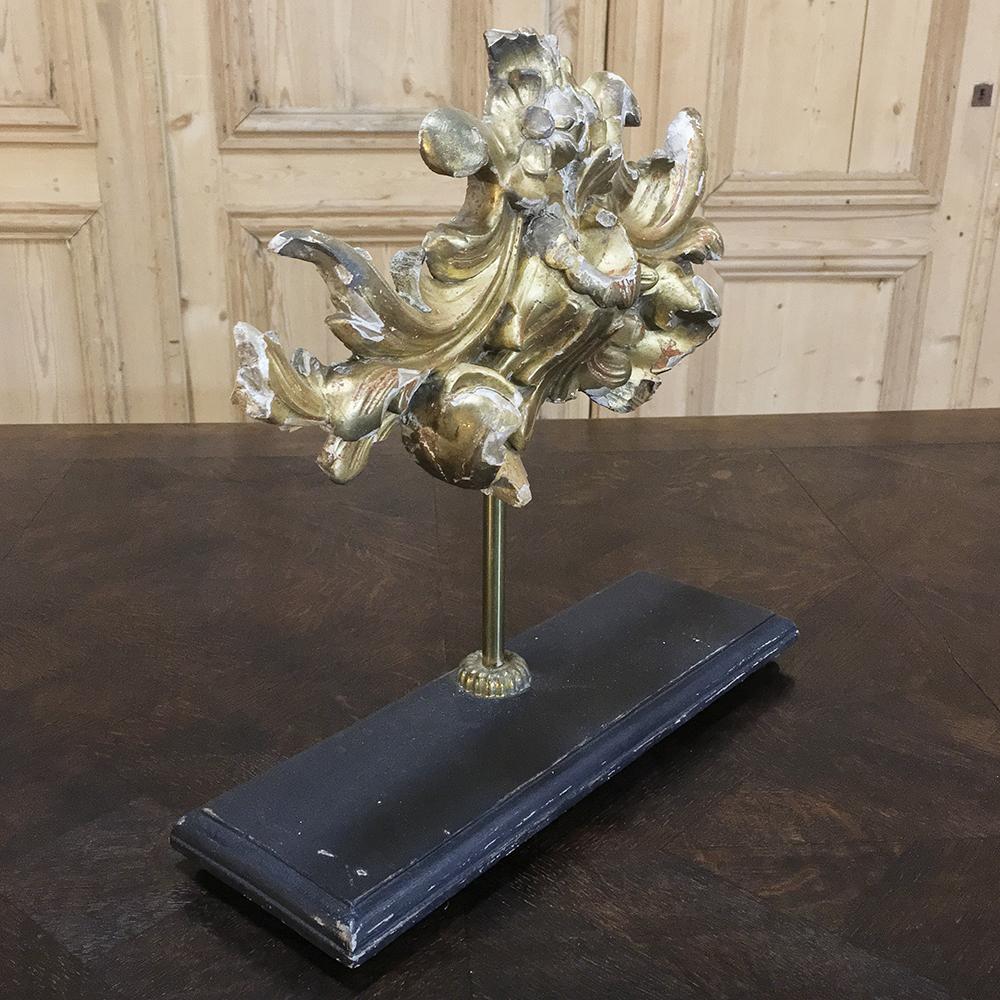 18th century giltwood architectural Remnant decoration makes an interesting conversation piece, and showcases wood sculpture at its finest, plus it retains most of its original gilding. Set upon a wooden base, suspended with a rod so it can be