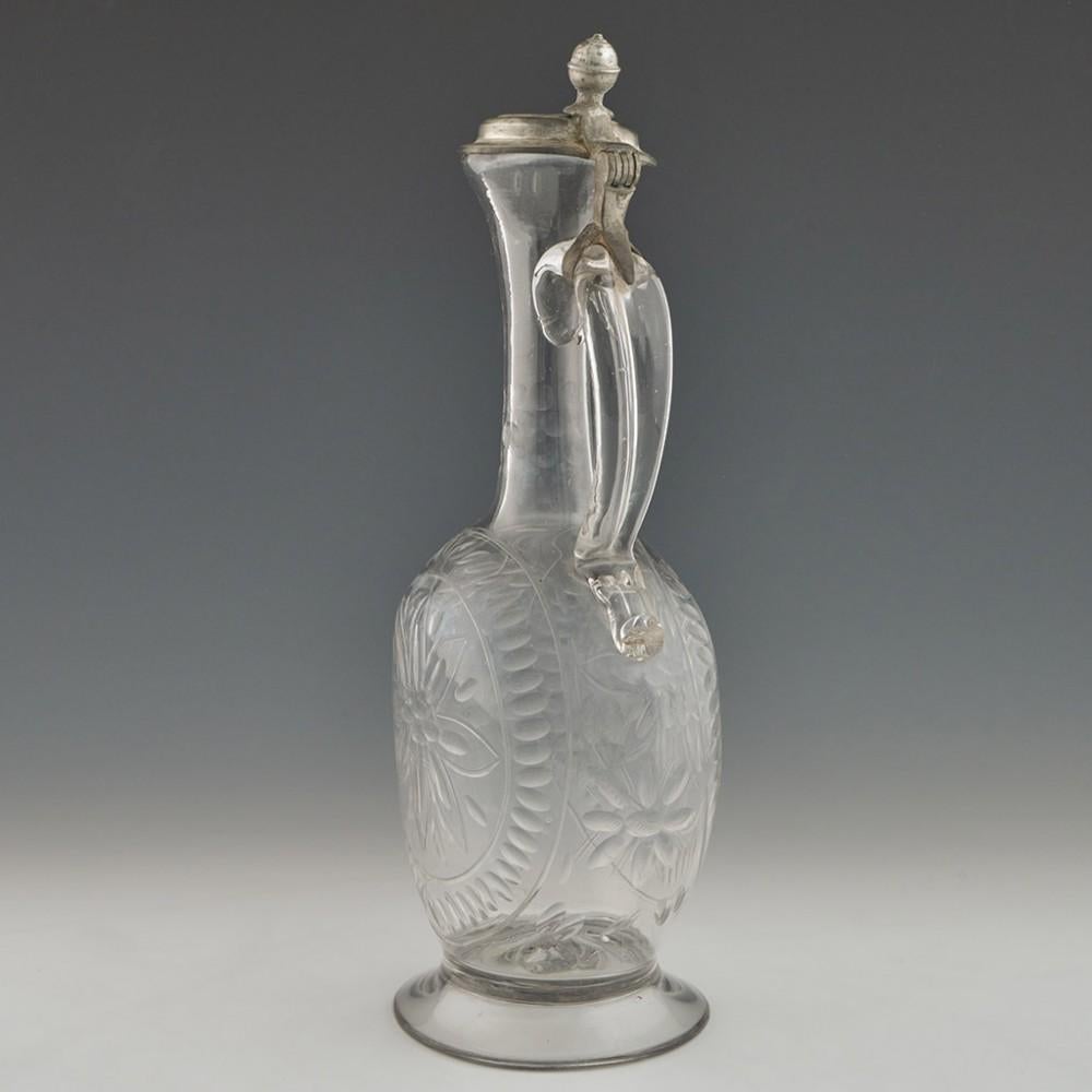18th century Glass and Pewter Claret Jug, circa 1780

Additional Information: 
Material: Glass, Pewter
Date: c.1780
Origin: Probably Bohemia or Germany
Colour: Clear
Stopper: Pewter cover with ball finial
Neck: Band of lens cutting to the