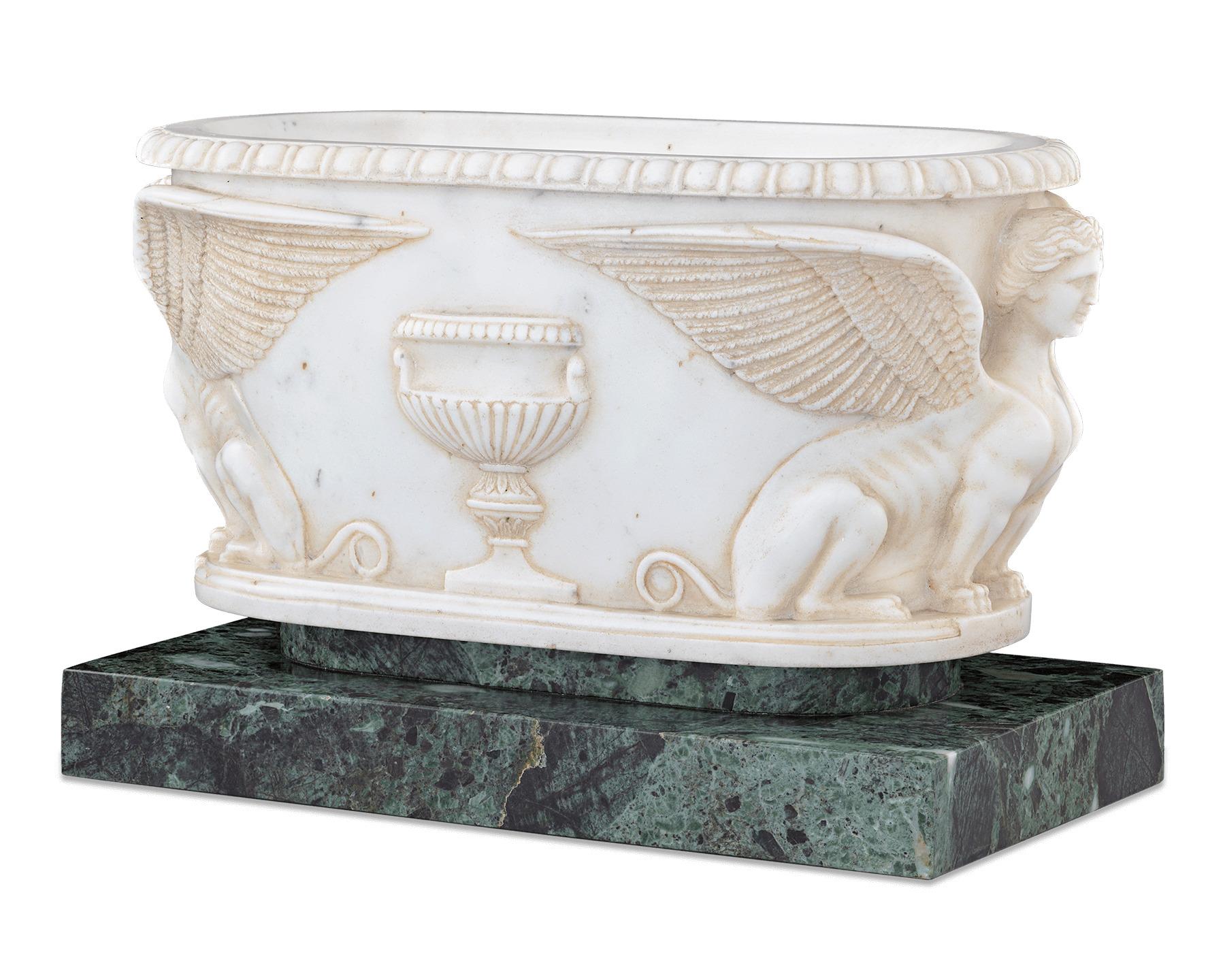 Almost certainly a memento of the aristocratic Grand Tour through Italy popular at the time of its creation, this rare and highly important 18th century marble was crafted in the form of an ancient Roman sarcophagus. Masterfully carved, finished in