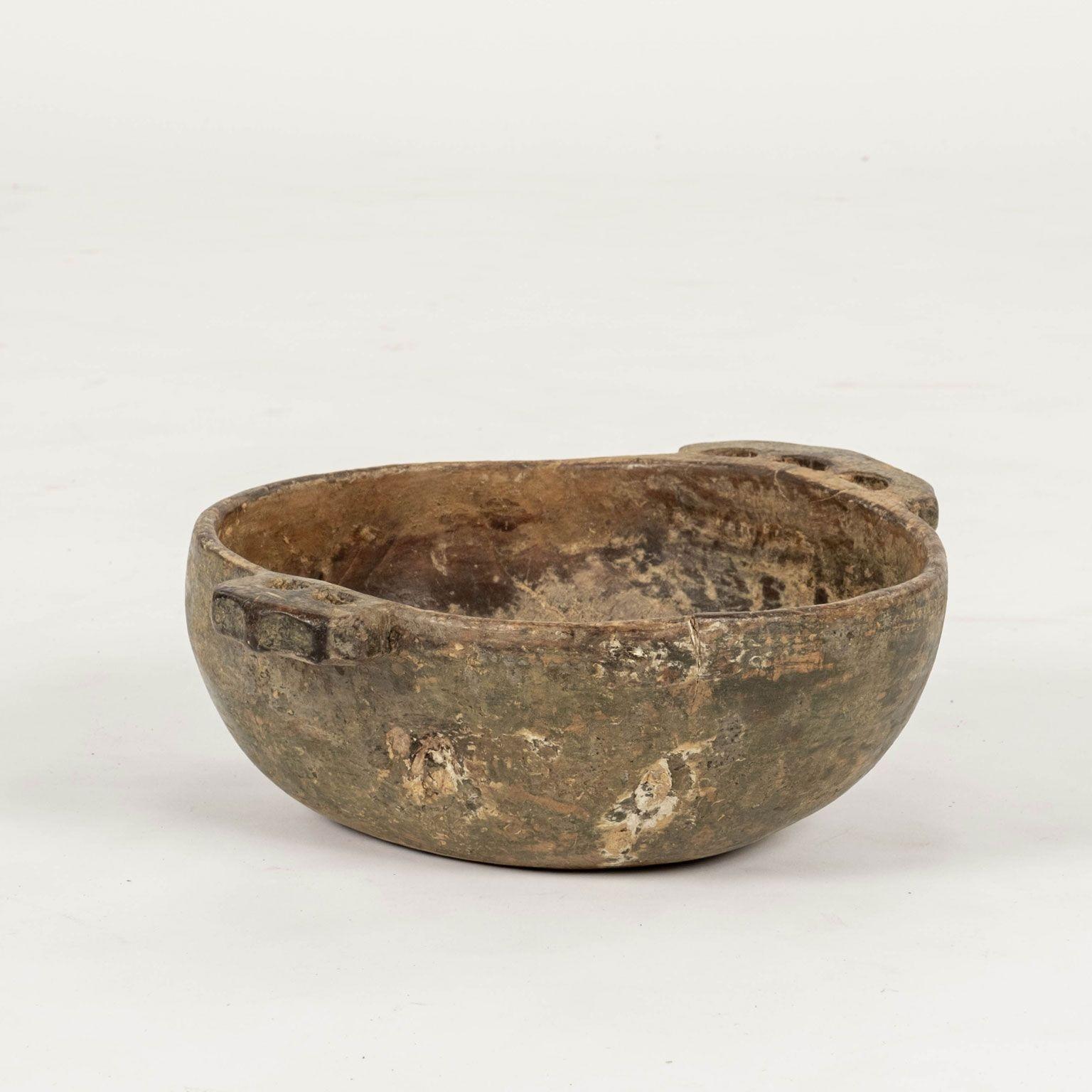 18th century green-painted primitive Swedish root wood bowl with handles. Hand-carved from burl root wood. Interior retains early brown-ocher paint, and exterior of bowl is scraped back revealing early green paint. Inscribed on bottom with initials