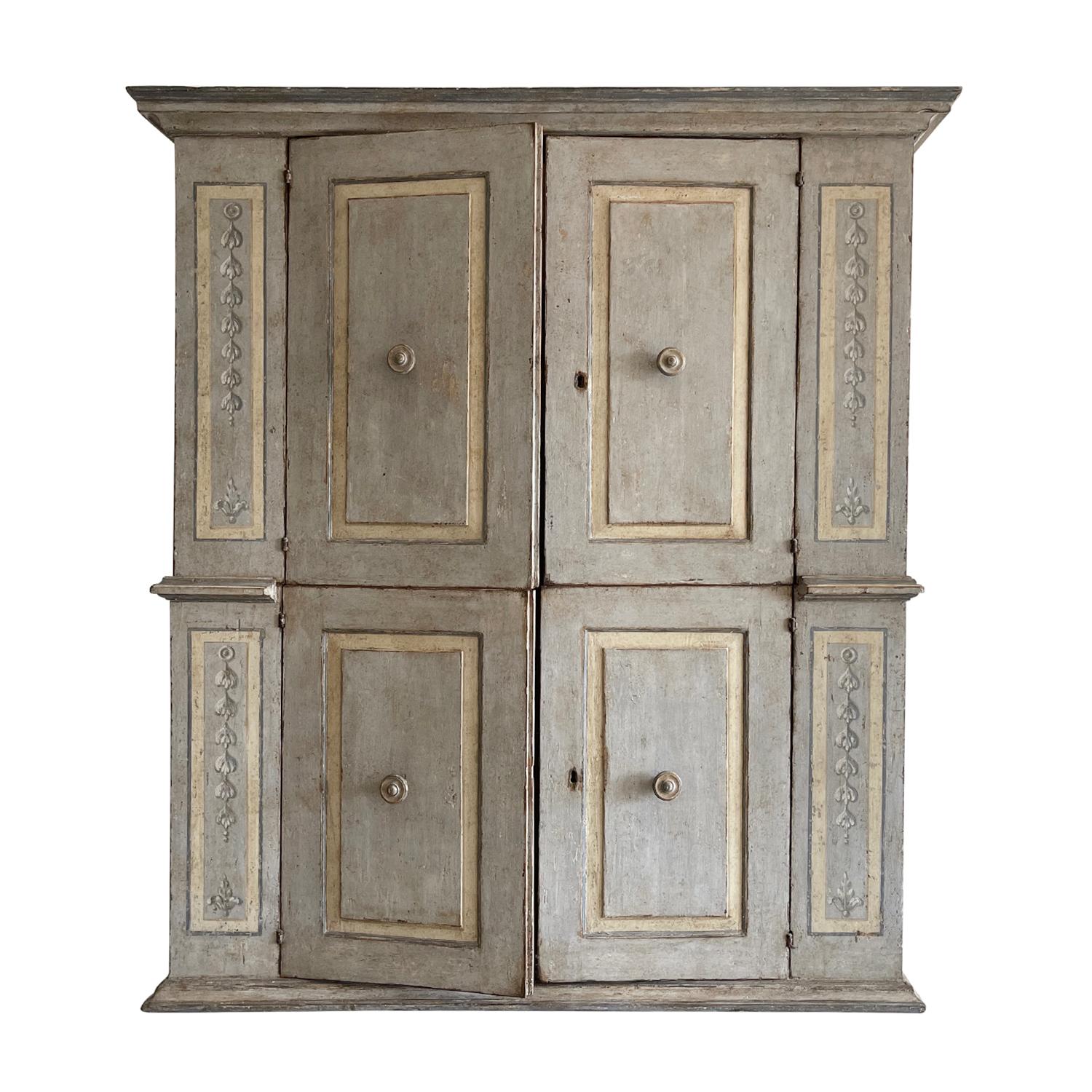 Late Renaissance style Italian armoire, closet or Quatrefollet in walnut with four doors, in good condition. Featuring a finish that shows the weathered patina grey with wooden doorknobs, composed with its original metal hardware. The recessed