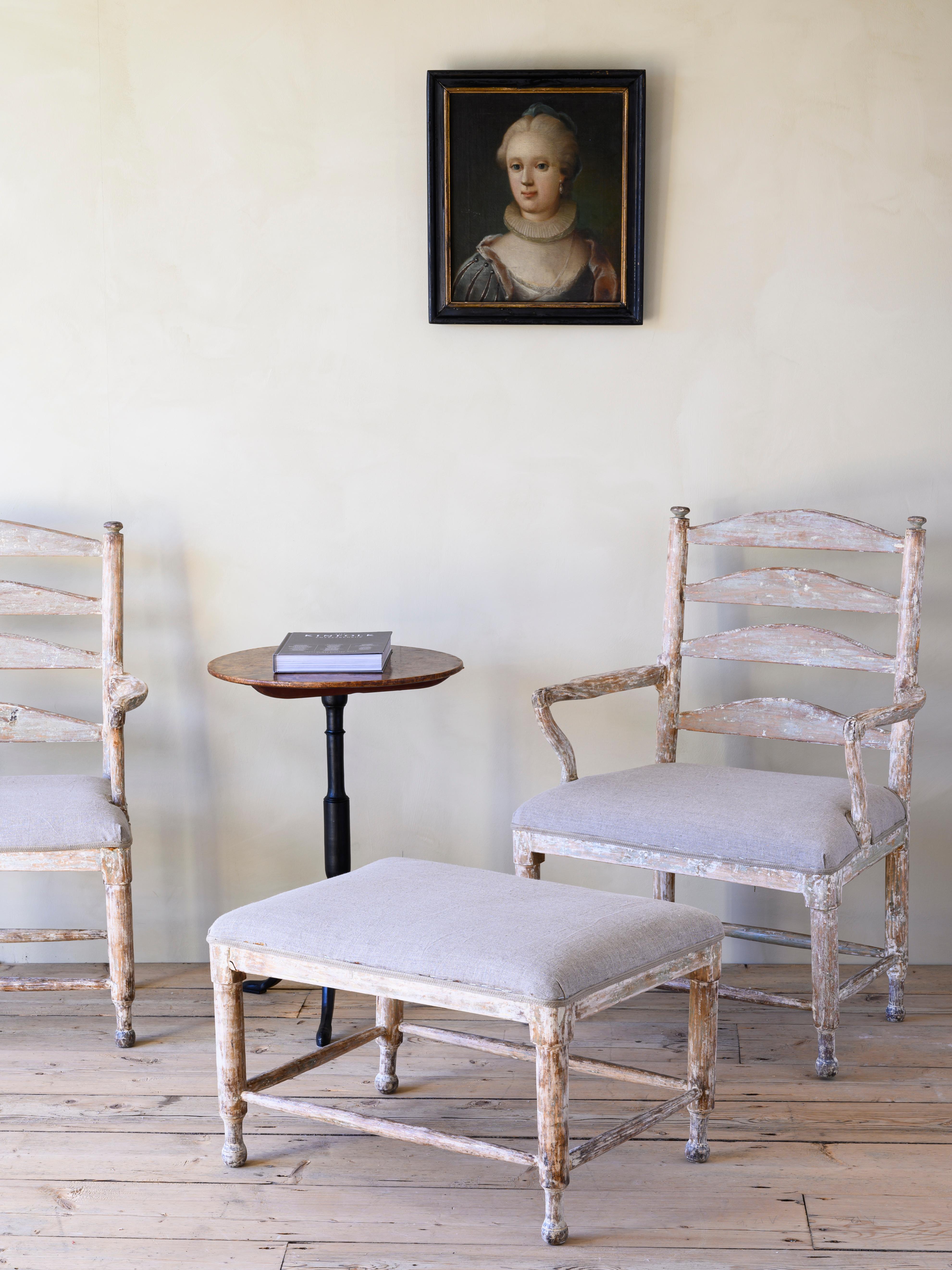 Good pair of 18th century Swedish Rococo Gripsholm armchairs with accompanying stool, circa 1775.

The armchairs got its name from the Gripsholm castle when the king Gustav III decorated most of the bedrooms with this model of armchair in the late
