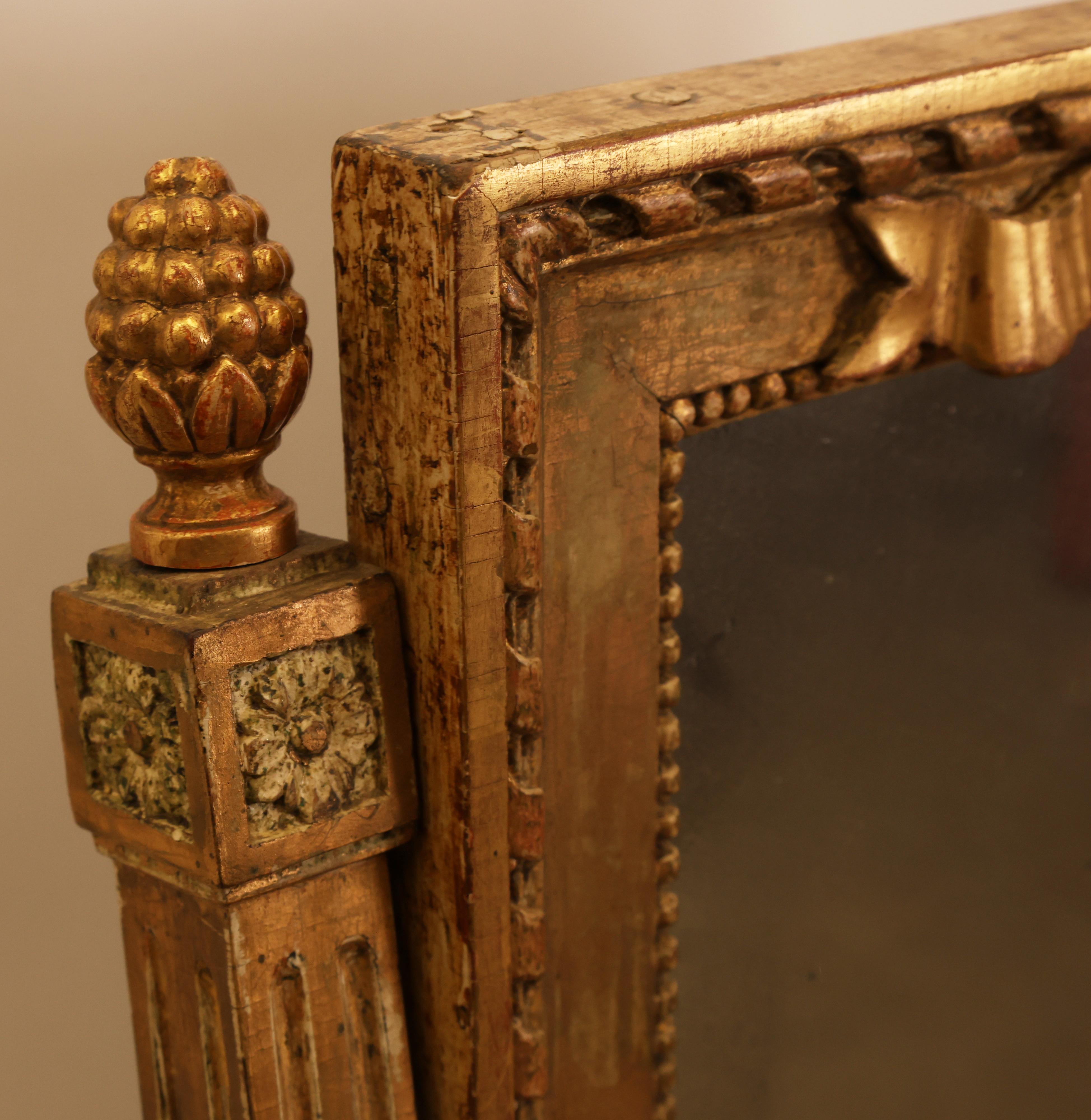 An early Gustavian work from Stockholm, Sweden dating back to the 1770s. The drawer mirror features a sophisticated lower section with flat-carved decoration and a rose in high relief. The mirror is supported by double columns crowned with