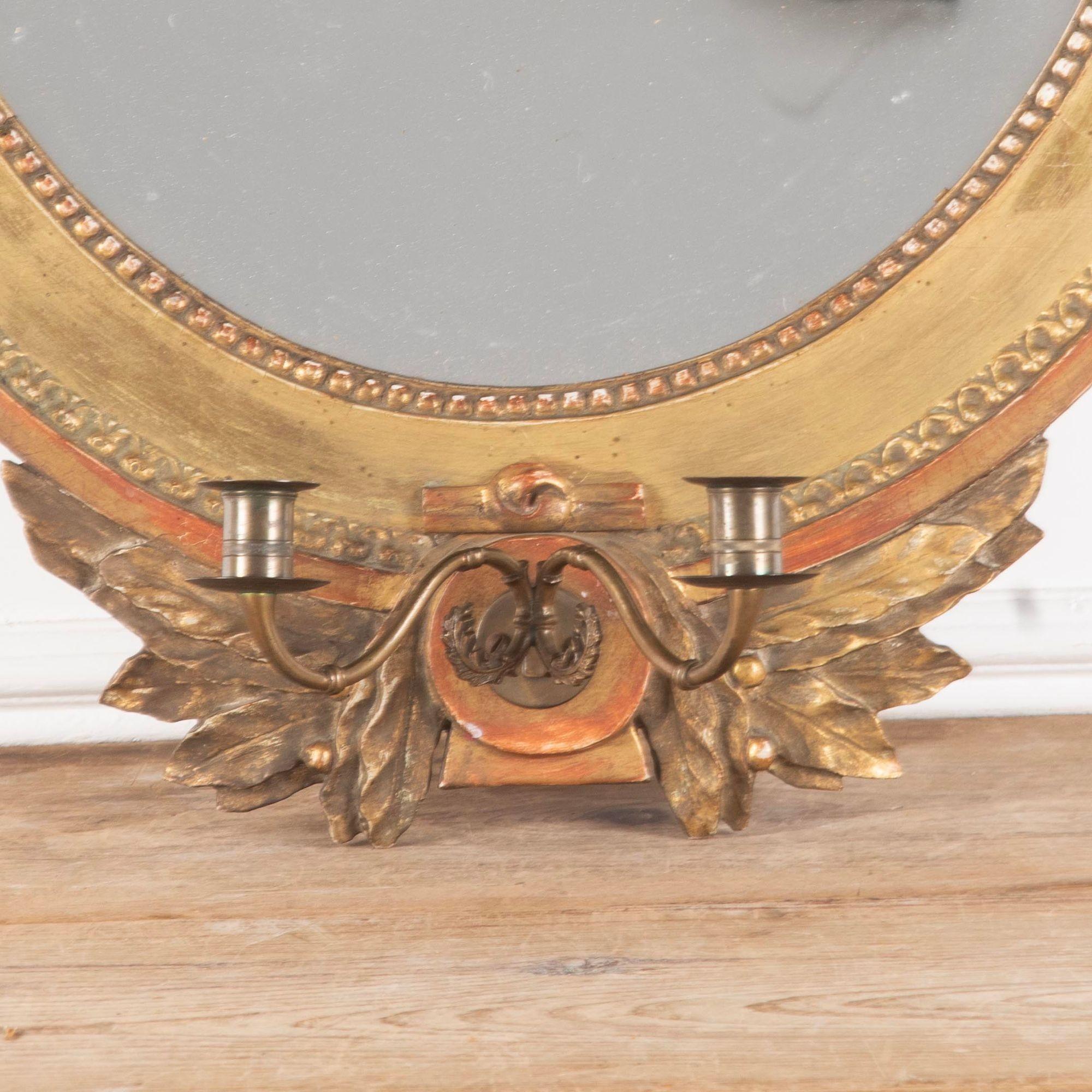18th Century Gustavian oval mirror.
With carved bow details to the top and bottom.