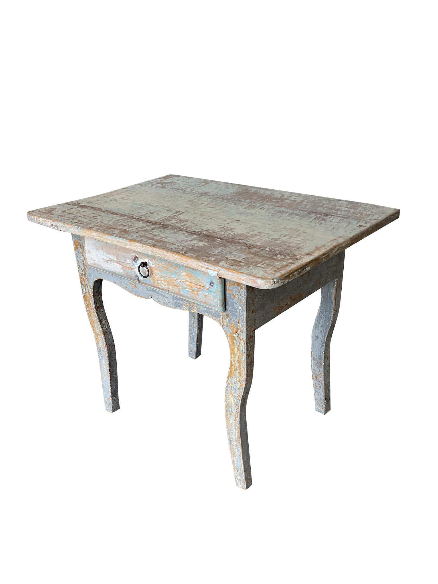 Late 18th Century Gustavian Era Swedish Wood Side Table. Crafted in solid wood that has patinated nicely into a blue-gray over time. Side table designed with cabriole legs, storage drawer, and aproned table top. 

Dimensions: 
36 in. Width
25.4 in.