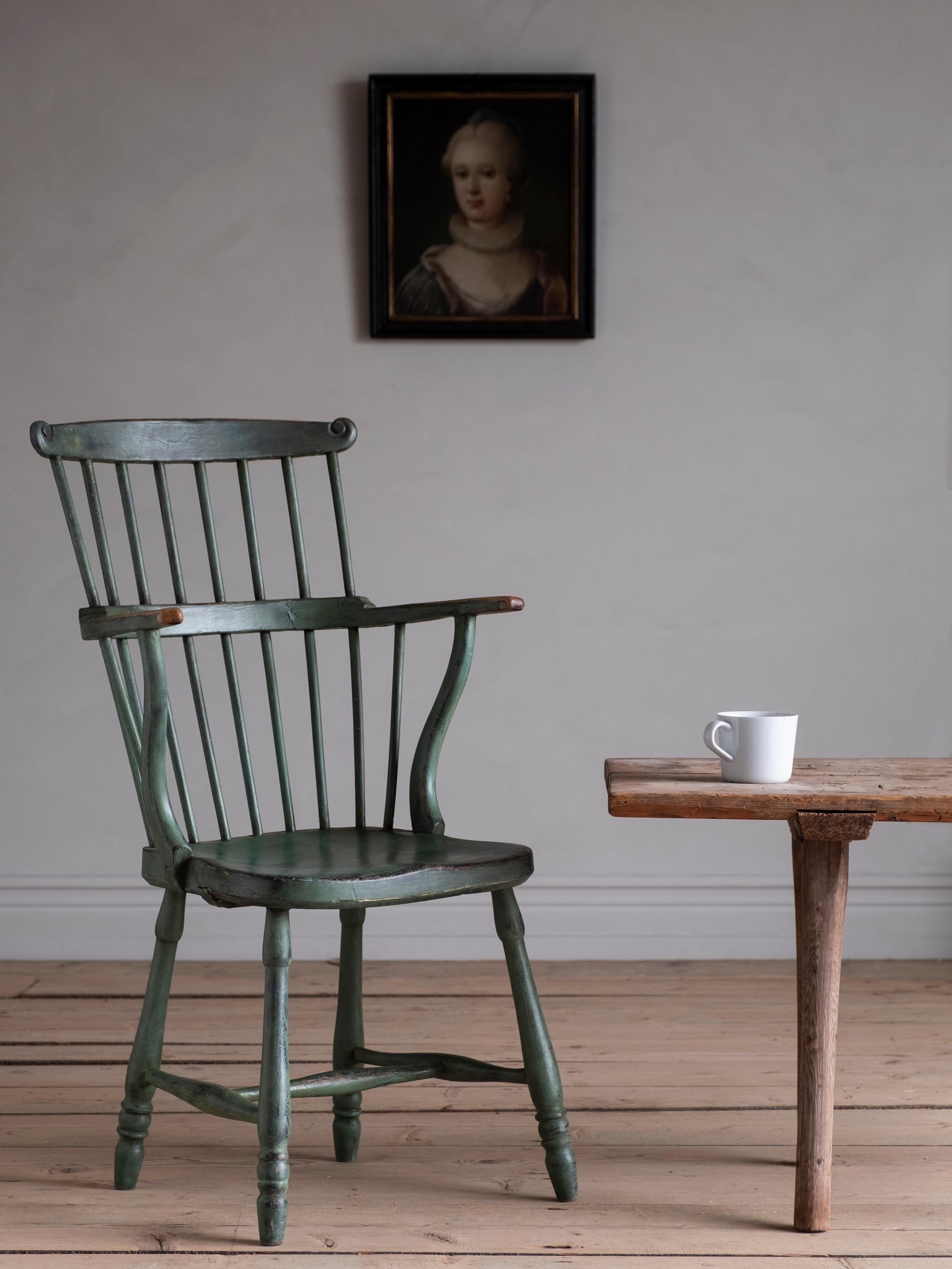 A rare 18th-century vernacular Windsor style comb back armchair from the Gustavian period in secondary historical color. Ca 1790 Sweden. 

Good condition with wear and tear consistent with age and use.