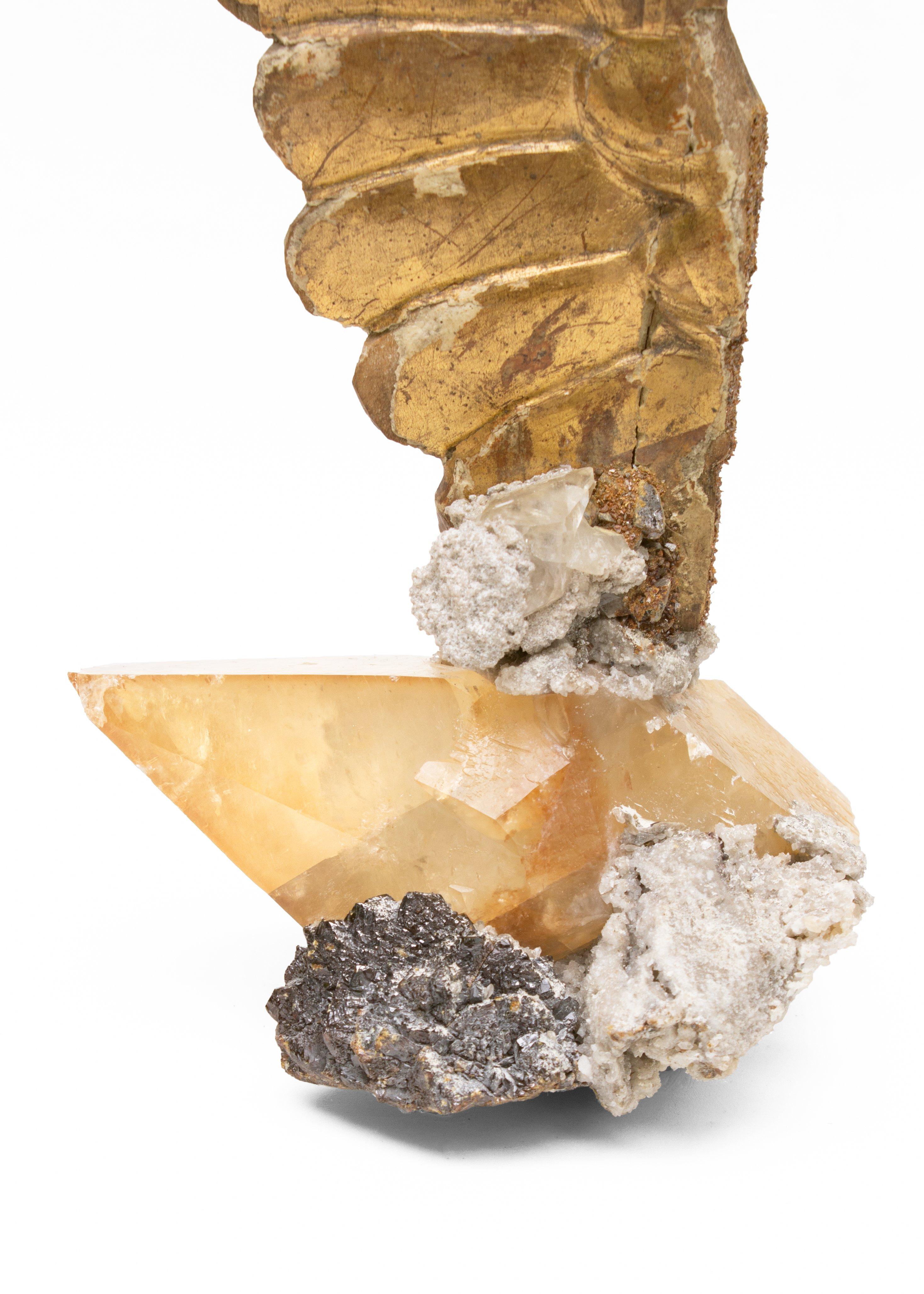 18th century Italian hand-carved angel wing on calcite crystals in a matrix of sphalerite.

The hand-carved gold leaf angel wing is originally from a church in Tuscany. The ecclesiastical artifact is adorned with calcite crystals in a matrix of