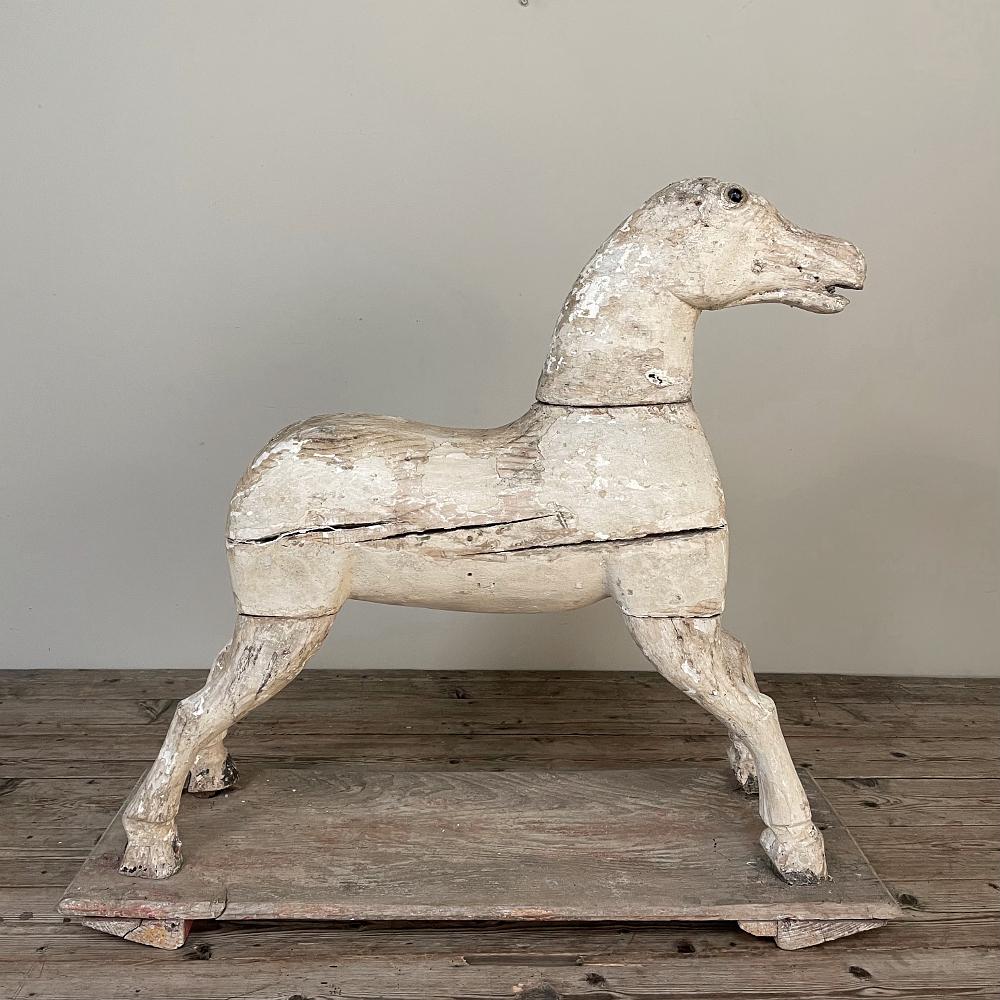 18th century hand-carved pine rocking horse has no doubt brought smiles and hours of imaginative fun to generations of youngsters over the centuries! Skillfully carved in a galloping pose, the faithful steed has decades of honest wear from all the