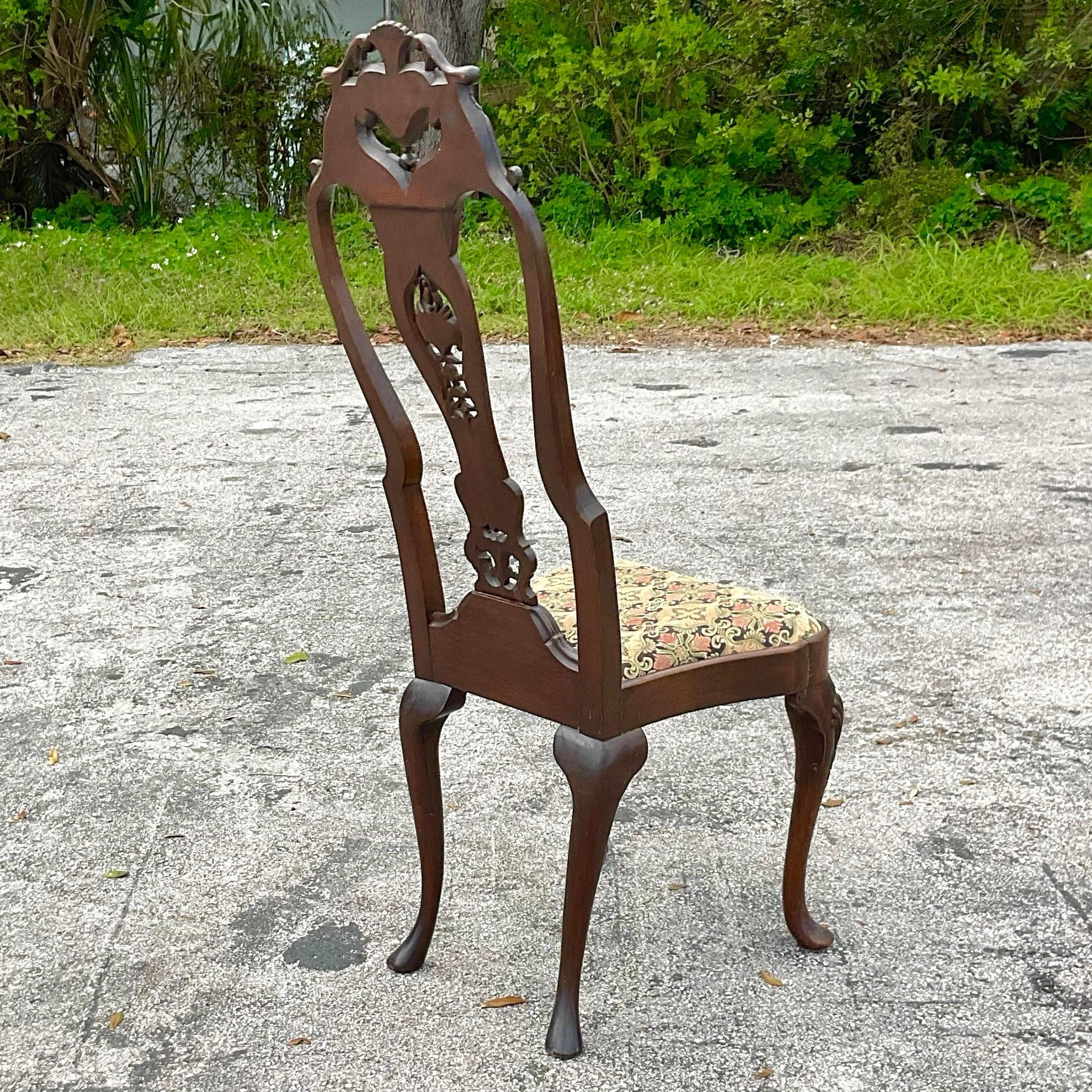 Incredible hand carved vintage chair, the splat and stile feature intricate fish scale carvings. The ornate cresting rail is adorned with shell mimicked in the apron. Features a slip seat. Incredible craftsmanship and age, immediately age elegance