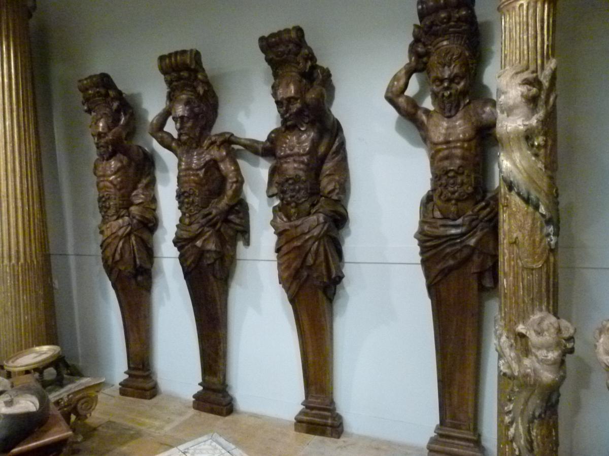 18th century handcrafted tropical wooden atlantes that belonged to a Portuguese Galleon.
The wooden carved base of the four figures was reconstructed in the 20th century. One of the figures is missing an arm. There were 6 figures on the Galleon but
