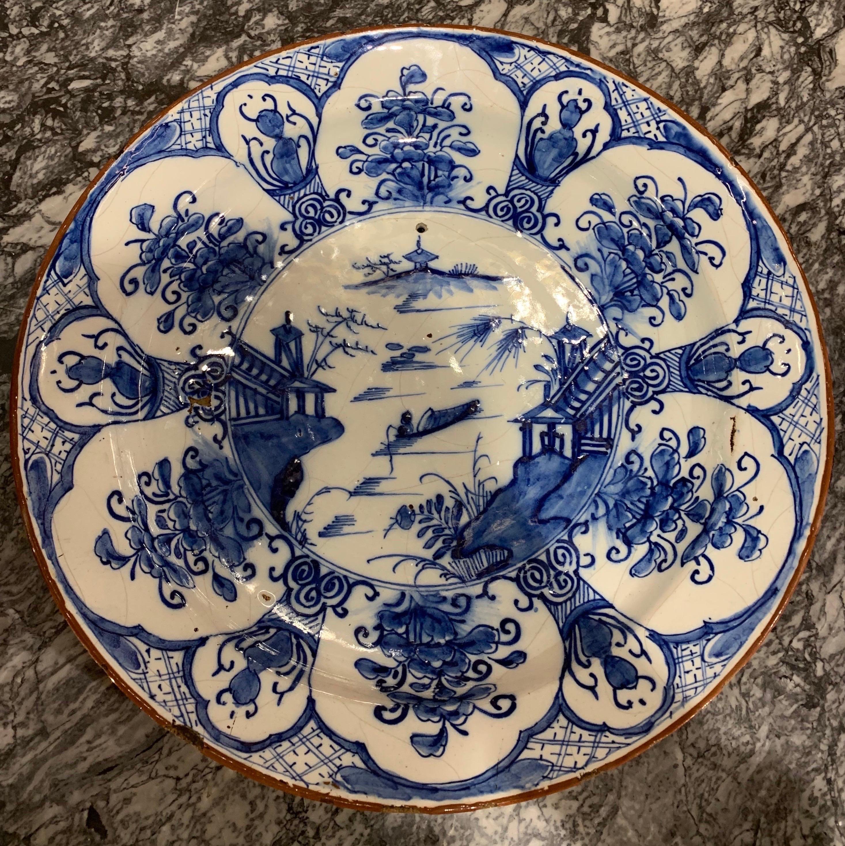 Great 18th century hand painted Dutch delft chinoiserie decorated platter. 13.25” diameter. Hole drilled for wall mounting.