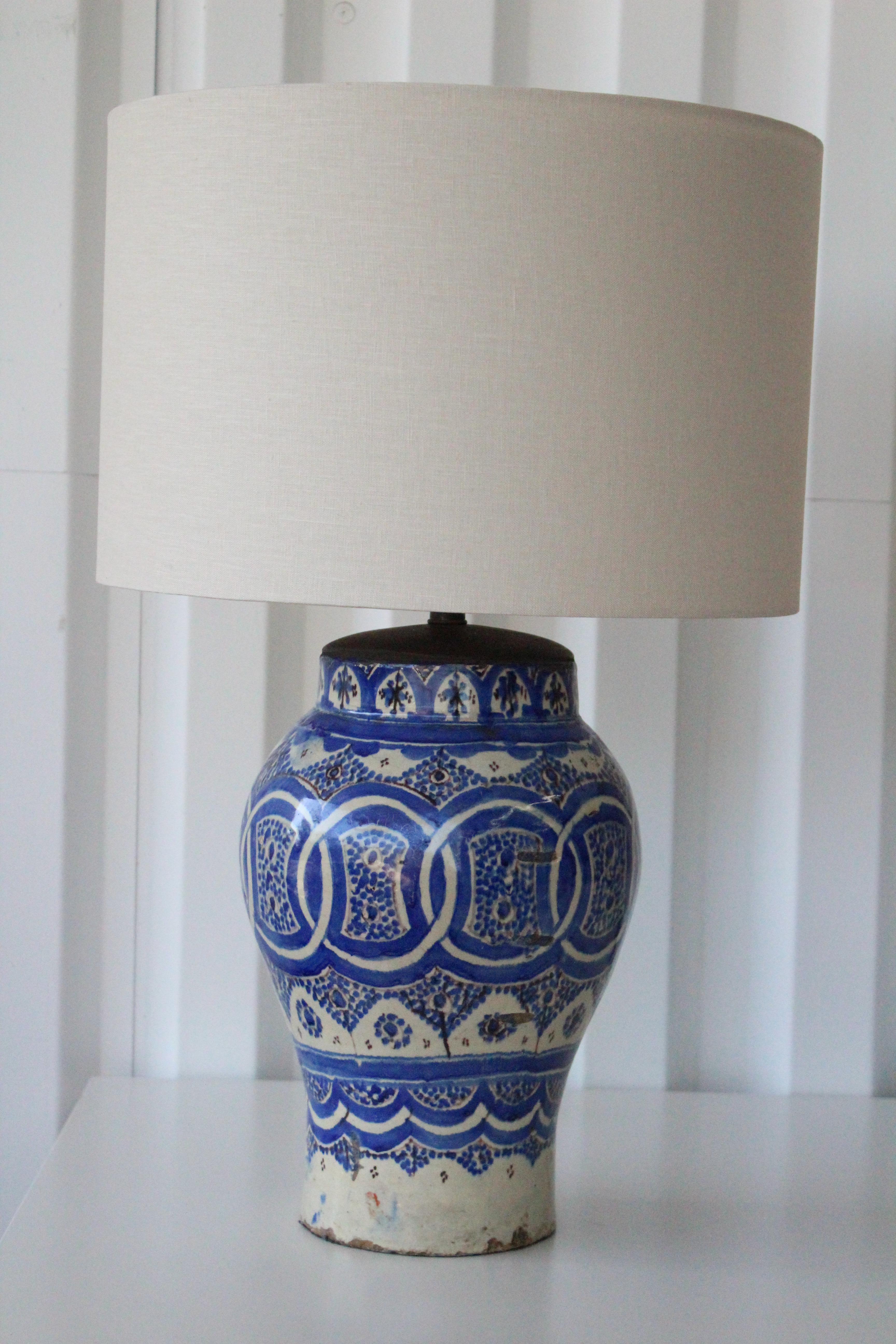 Beautiful pair of 18th century hand painted Persian pottery vase table lamps. These have been custom made into table lamps and have all new wiring and custom linen shades. Each hand painted lamp shows age appropriate patina. Pair available, sold