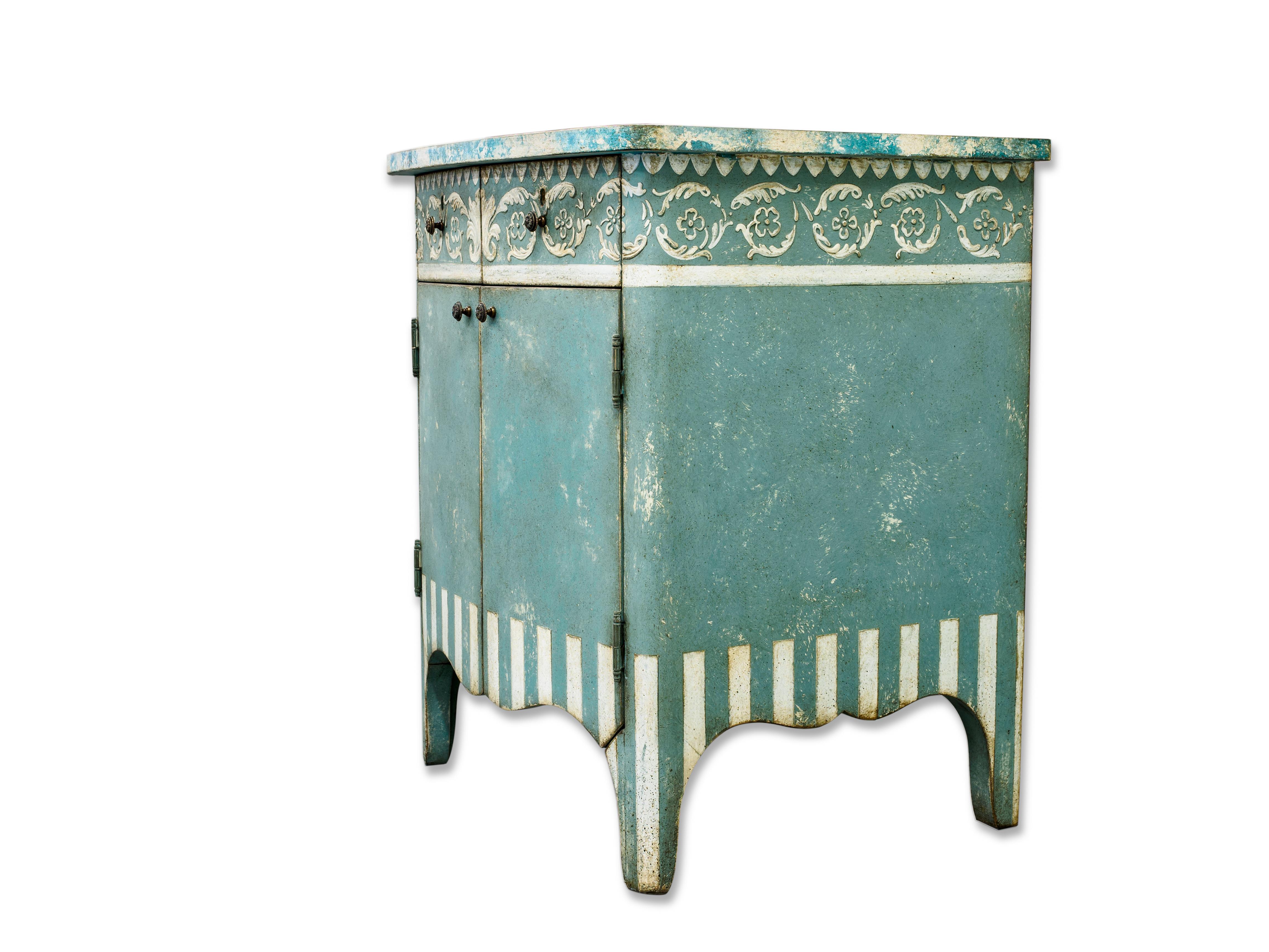 From our Hand-Painted Furniture Collection, we are pleased to introduce you to our Blue Dorsoduro Cabinet with stripes. 
This beautiful piece is finished with a classic ornament, framing the two tops drawers. The legs and sides are completed with