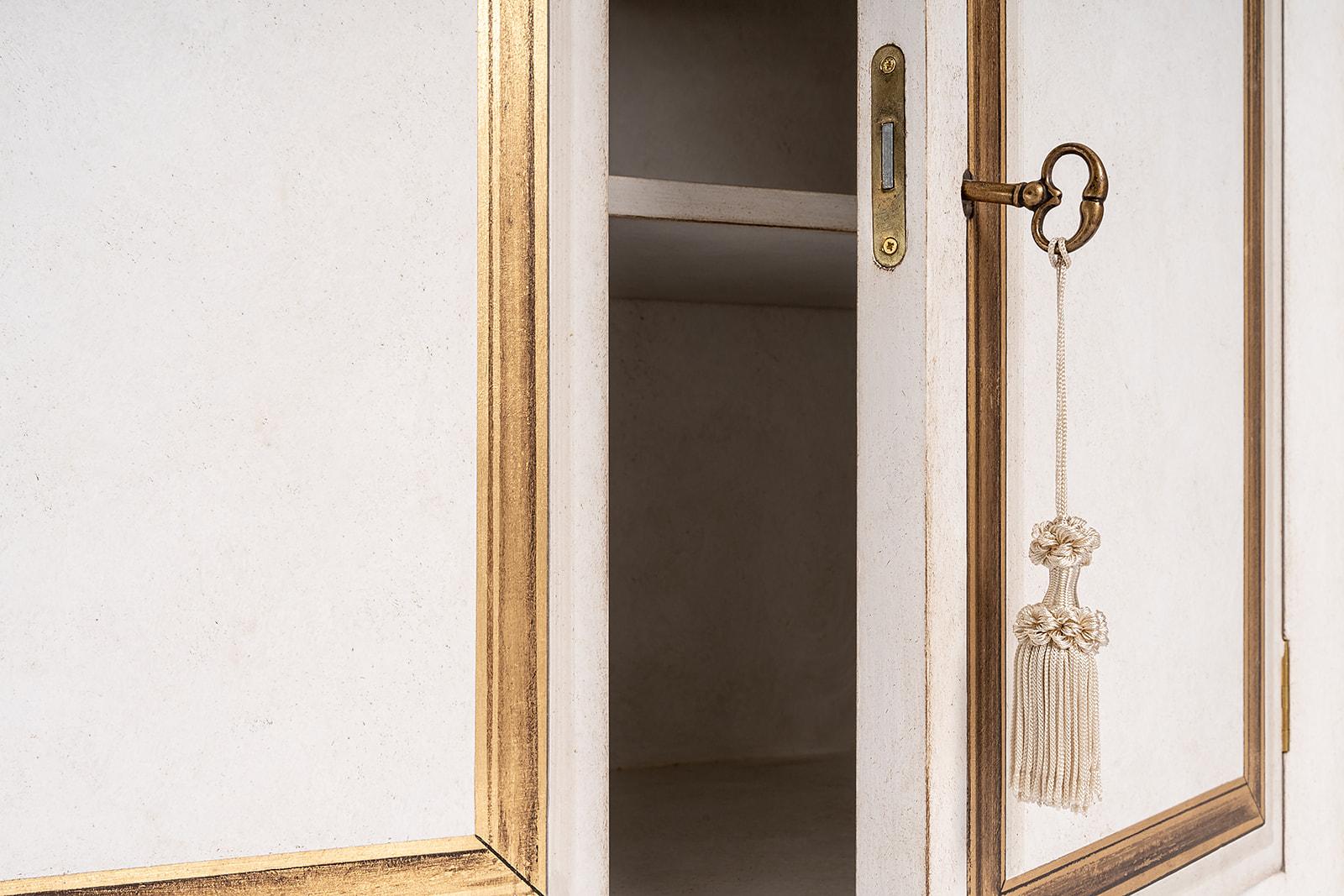 From our Hand-Painted Furniture Collection, we are pleased to introduce you to our Barberini Cabinet with Internal Shelf.
This beautiful piece is completed in Chalky White with trompe l'oeil decors in gold-leaf on each cabinet door - contemporary