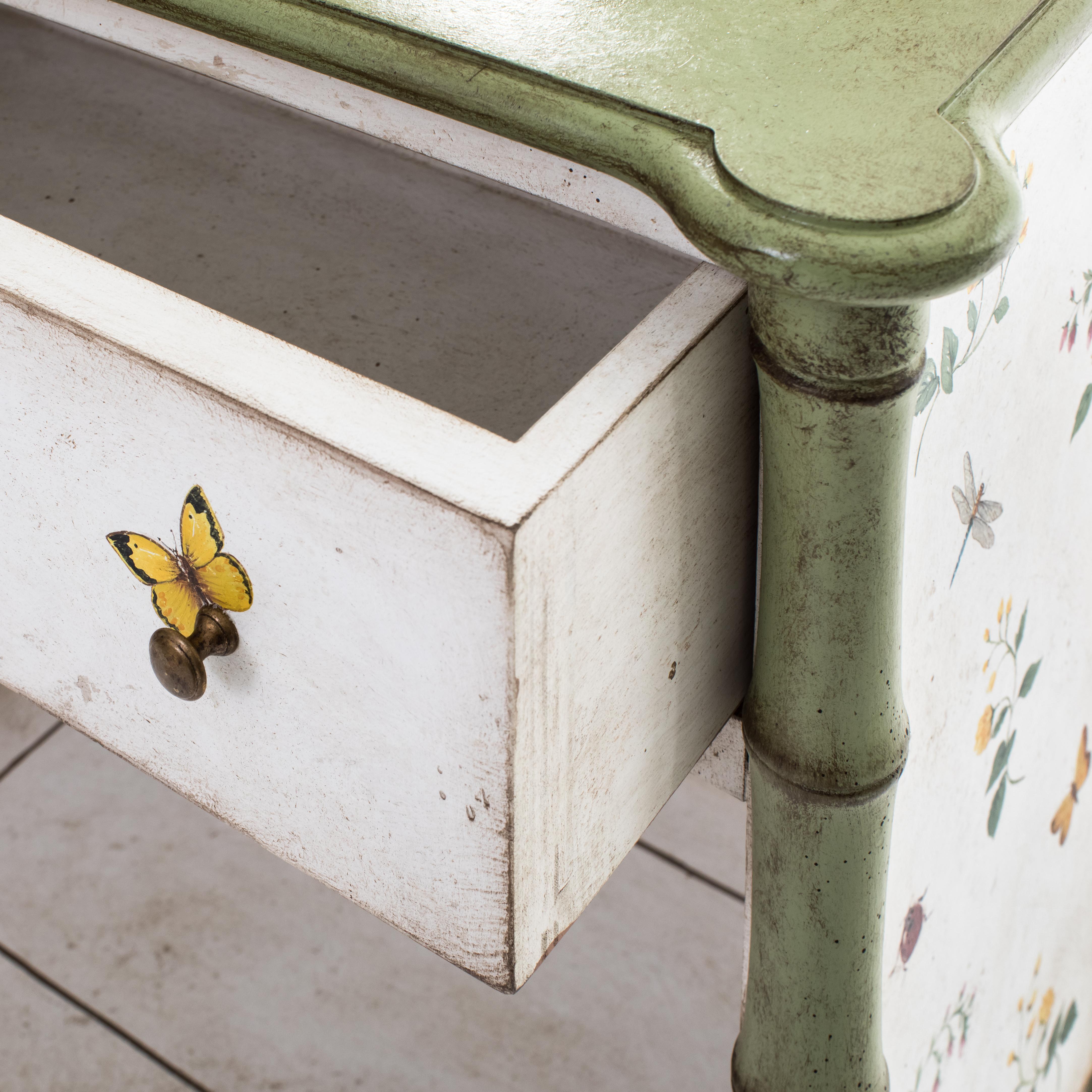 From our hand-painted furniture collection, we are pleased to introduce you to our Lombardia Bamboo Nightstand with shelf. 

A serenade in apple green, sweetly hand-decorated with little colorful flowers, butterflies and even a ladybug, gently