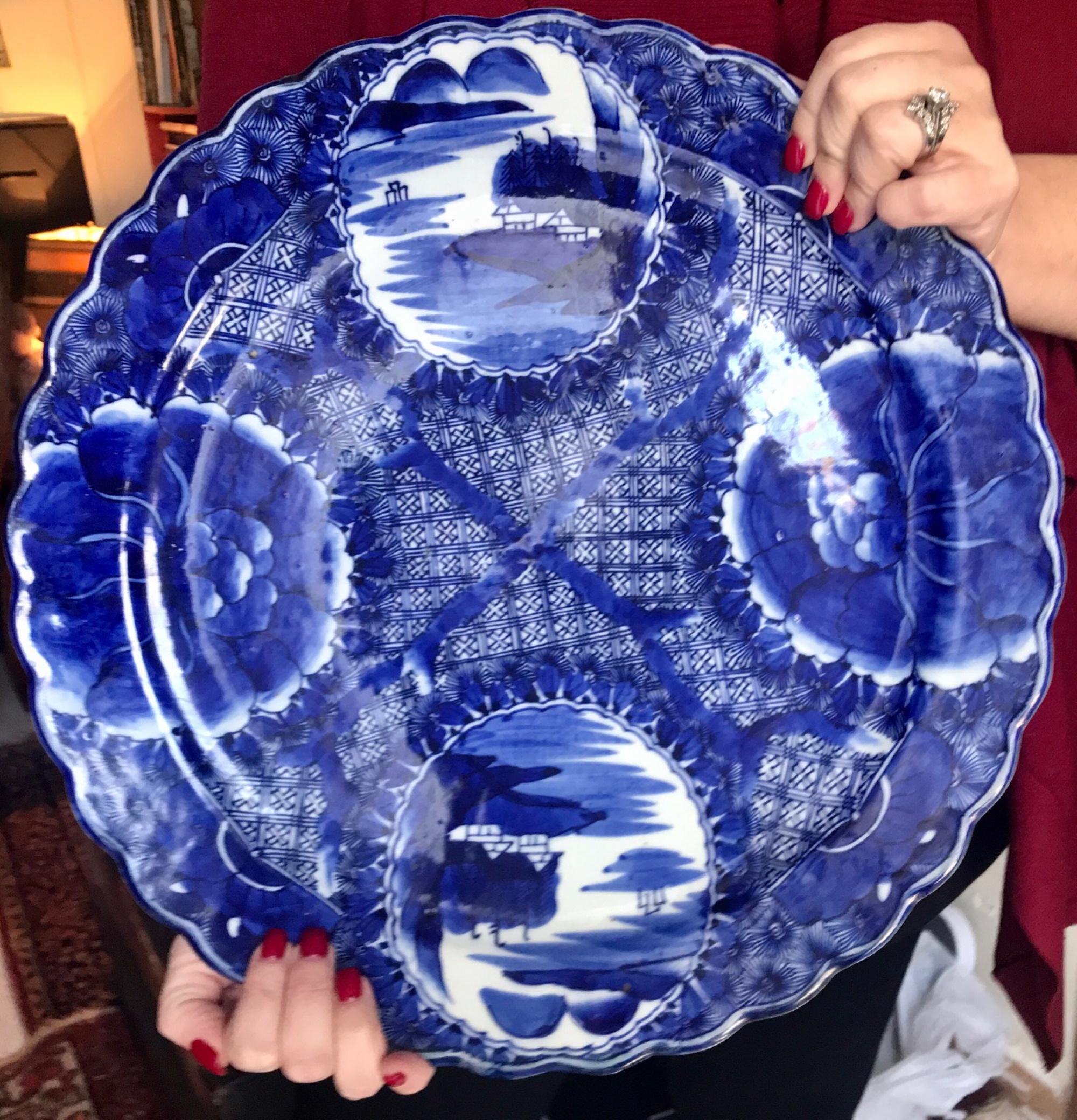This large, beautiful and bold blue and white platter is Japanese Imari from the Edo period (18th century). This impressive early porcelain Imari ware is saturated in rich cobalt blue underglaze hand painted in an unusual cross pattern. It features