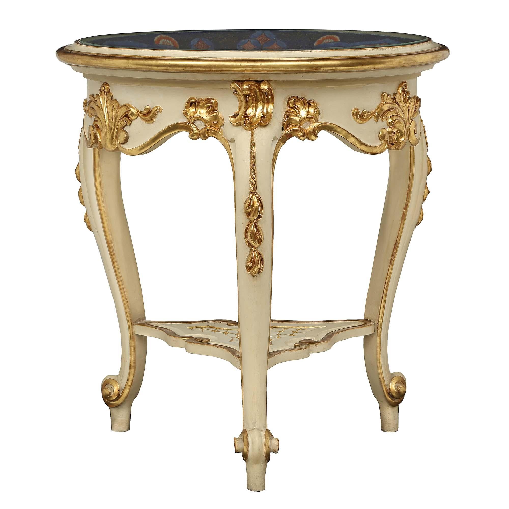 A unique and most decorative side table with an 18th century Imari bowl fitted in its original Italian 19th century Louis XV st. patinated and giltwood base. The table is raised by elegant cabriole legs with richly carved floral giltwood accents and